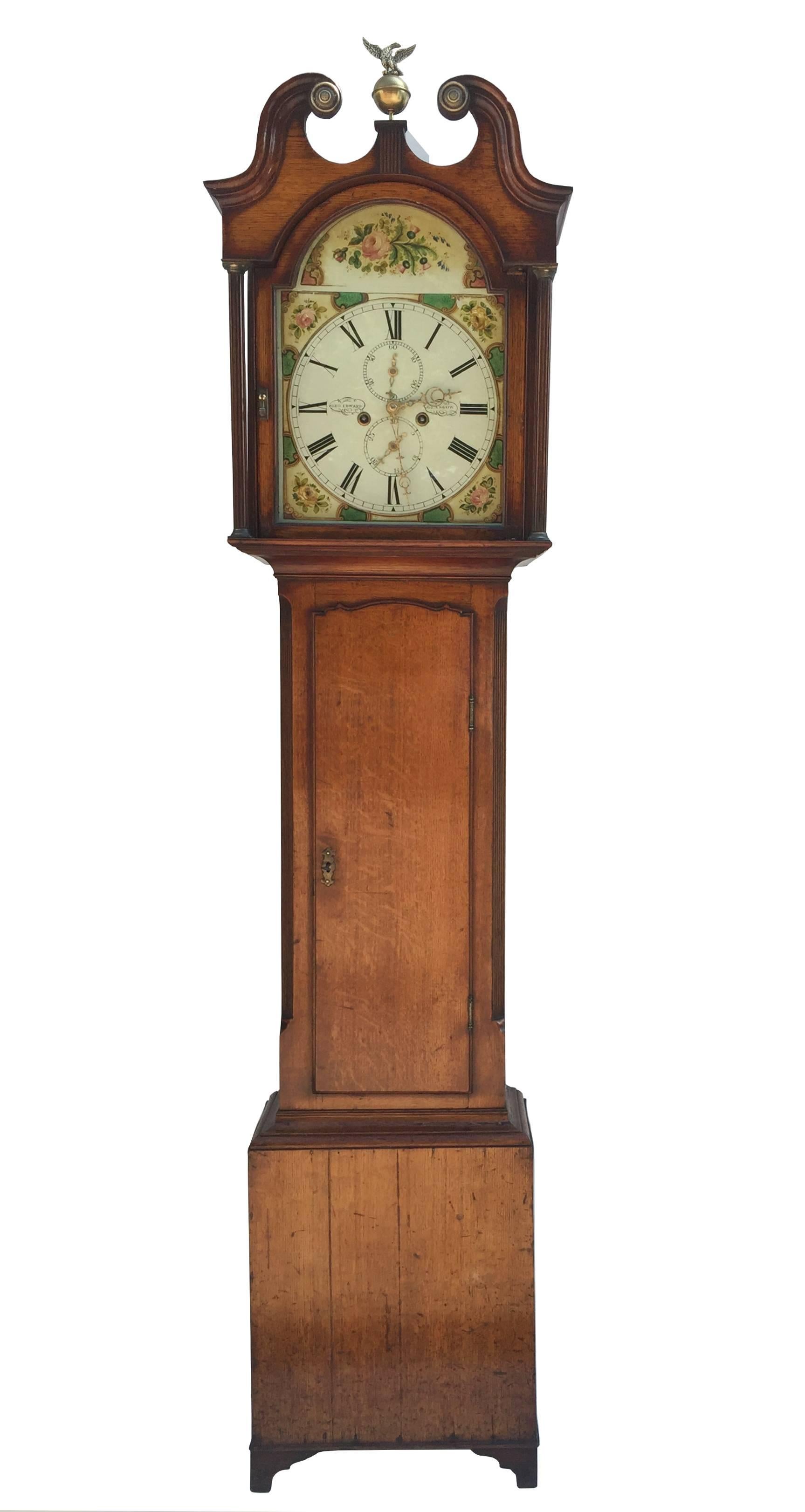 
This clock is of lovely proportions, with a swan neck hood centred with brass eagle finial. The arched dial finely painted both in the arch and in the spandrels in floral motif depicting roses. The dial with roman numerals, also with second hand