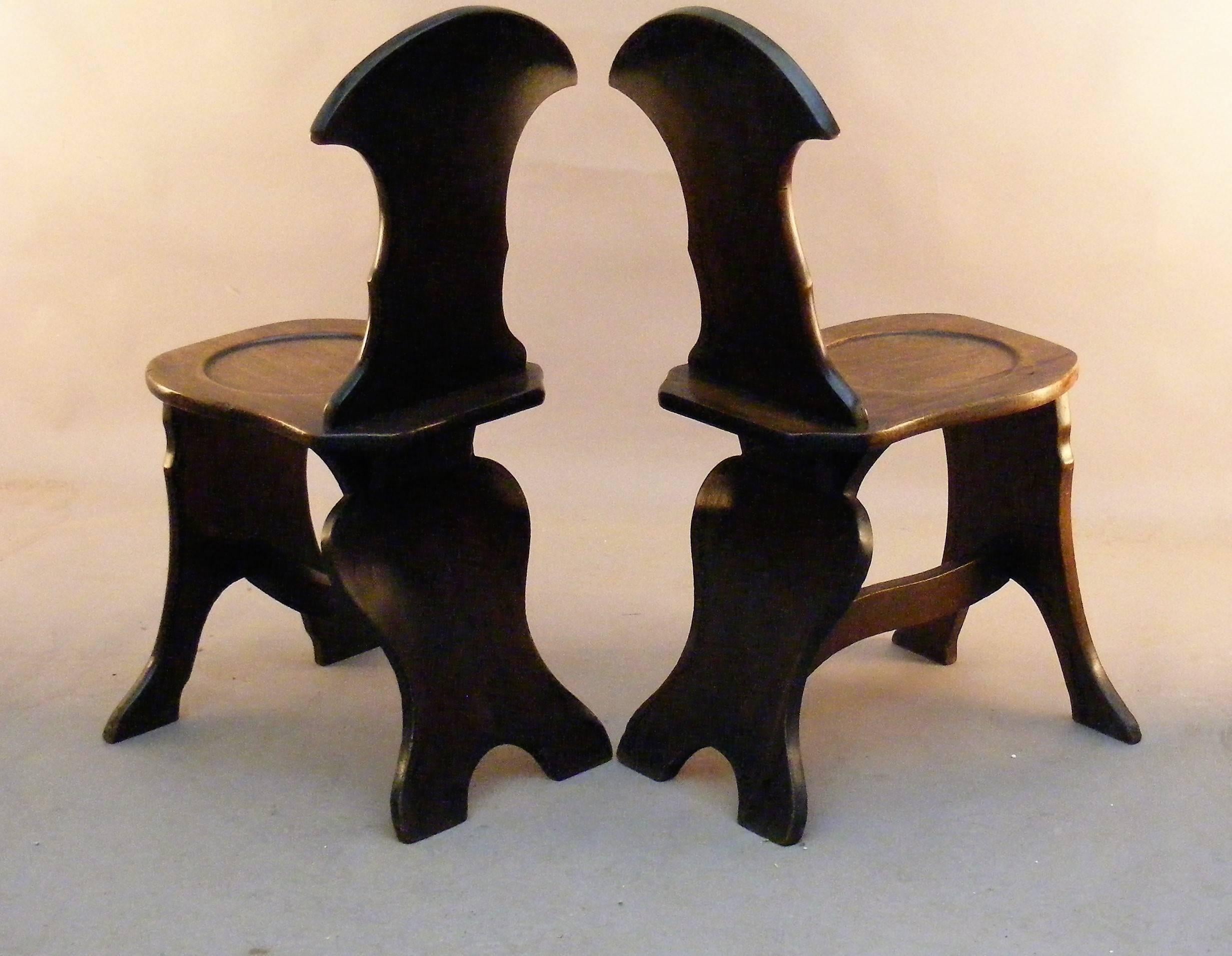 This pair of Chippendale mahogany hall chairs of the Georgian 18th century period made, circa 1770 of unusual form elegantly shaped back seat and legs taken from on plank of mahogany the seat dishes in balloon form similarly so the facade of the