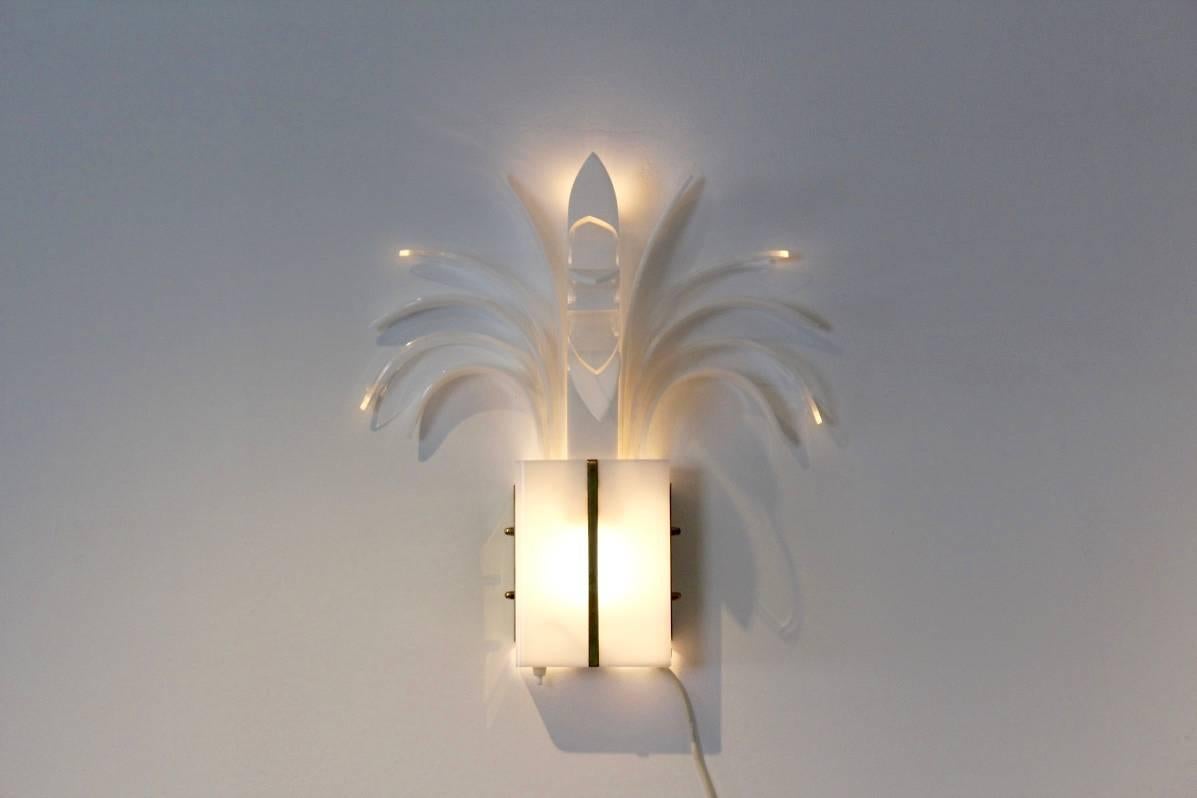 This exotic wall lamp was designed by Theo Verhulst in the 1980s. It is made from a combination of perspex and brass. The base is translucent and serves to illuminate while the top has a decorative function. It is in an excellent vintage condition