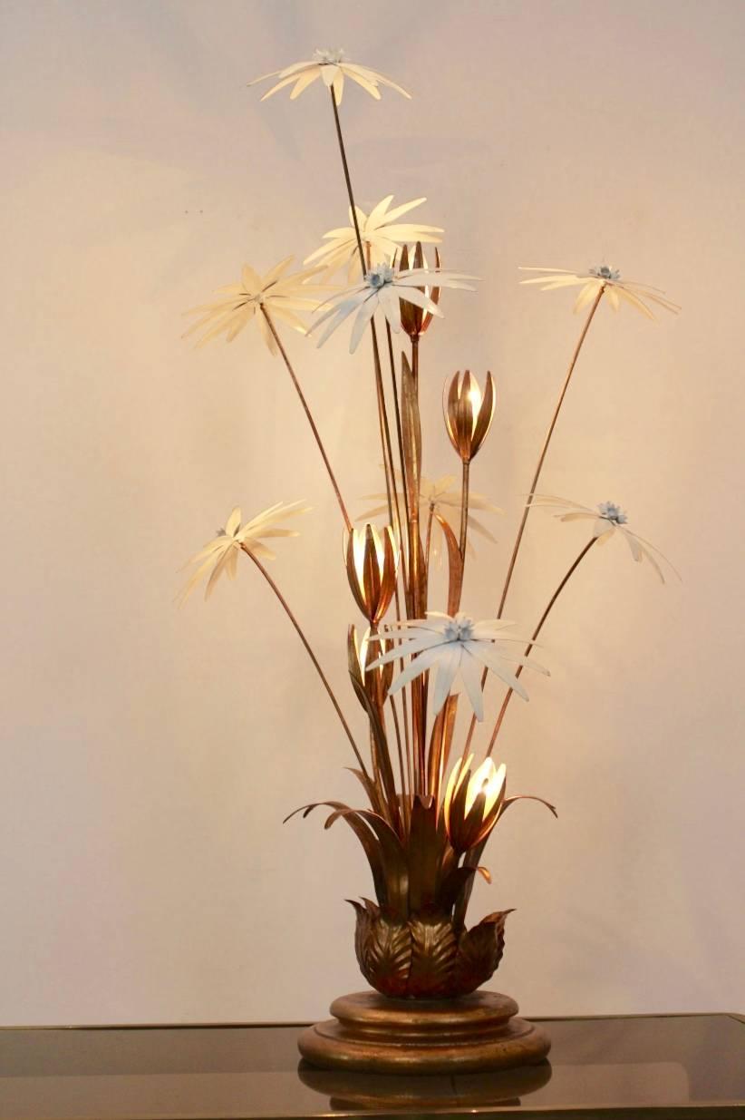 Exotic Hollywood Regency style gilt floral floor lamp. Designed in Germany by Hans Kögl in the 1970s. This classy and rare floor lamp has five lights mounted in beautiful gilded floral metal leaves. Decorated with nine enamel white flowers. With a