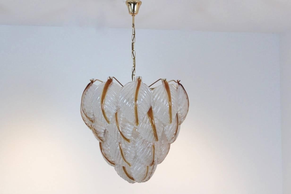 Wonderful chandelier made by A.V. Mazzega with 31 beautiful characteristic Murano frosted glass leaves on a brass base. Manufactured in the early 1970s. Very impressive large glass chandelier and beautiful light effect when lit. In excellent