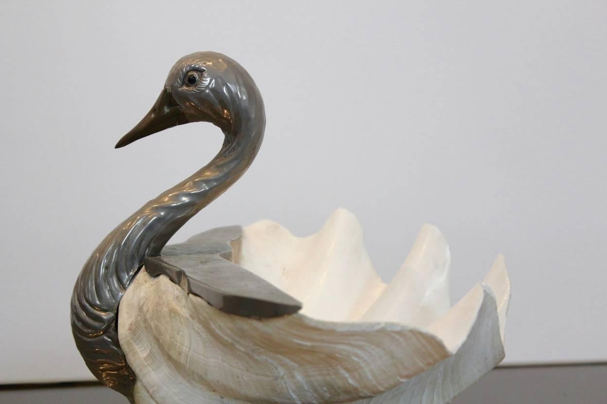 This beautiful large clamshell swan is designed and handmade by Gabriella Binazzi. She creates original and unique objects using strange materials such as ostrich eggs from stock farms and exotic shells from the Indian Ocean, like in this piece.