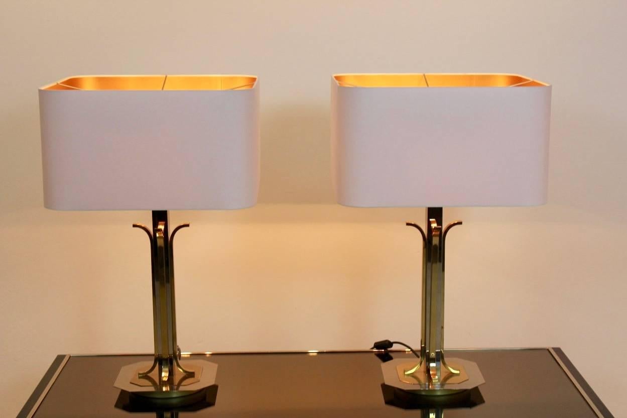 Beautiful pair of large brass and chrome midcentury table lamps from the 1970s in Willy Rizzo style. The set is unique and has a glamorous appearance and has four lights per lamp. The beautiful white shades are new and give a very sophisticated and