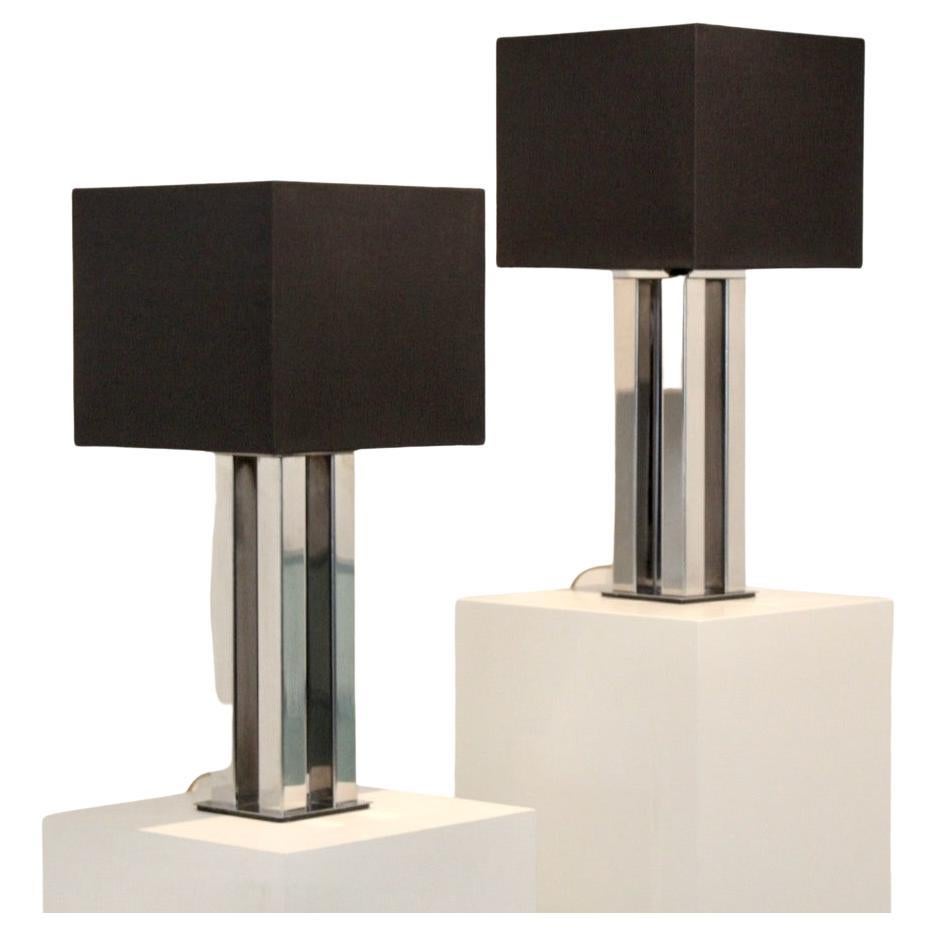 Sophisticated Pair of Chromed Boulanger Mid Century Table Lamps from the ‘70s. 
The square chrome bases combined with the classical square bars give these lamps their modern and sophisticated geometric form. The set features the original black