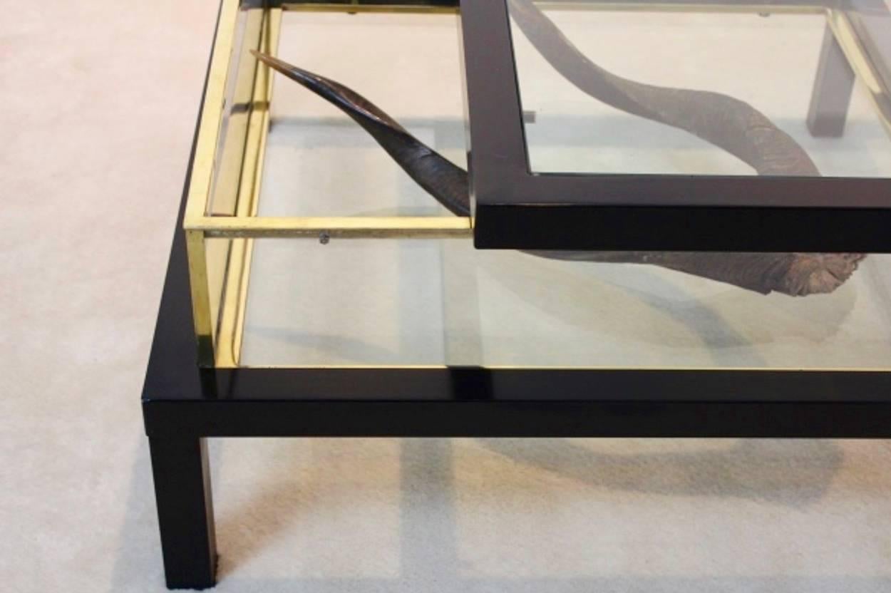 Spectacular modernist Romeo Rega coffee table with sliding top made in Italy. The heavy metal frame has an total original black finish with brass surroundings in the display part. One of a kind table with a fantastic display function. In original