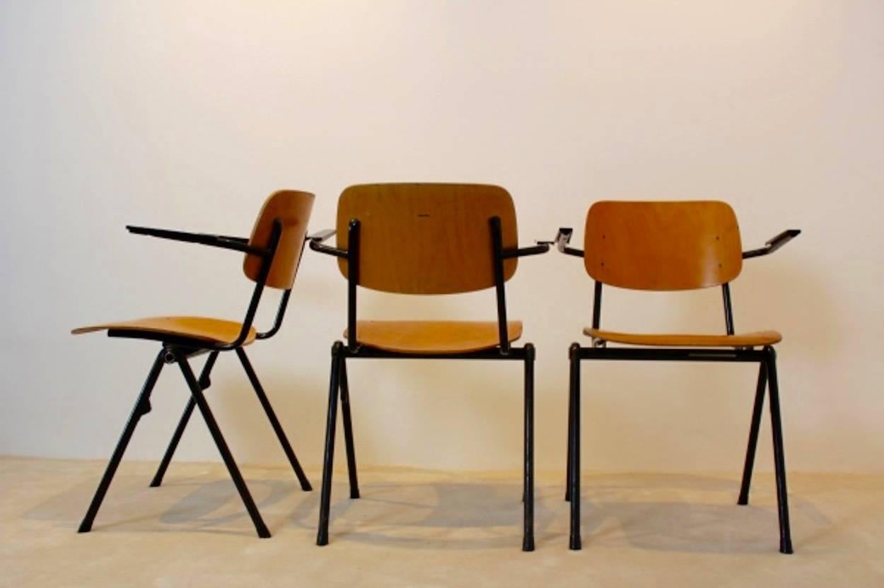 Very comfortable Industrial Marko Plywood school chairs, produced by Marko Holland in the 1960s. The chairs have a black tubular metal frame and beautifully curved plywood seats and backrests. All with armrests made from Bakelite and also stackable.