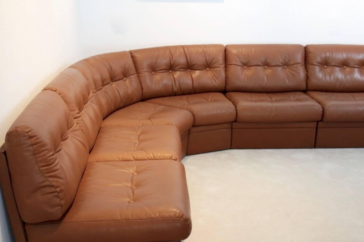 Exceptional grand sectional sofa in cognac leather. Nice six-pieces made on a solid frame of wood. The different seats come from the same set, so they have the same beautiful patina. You can adjust the sofa in any wanted position, also in a