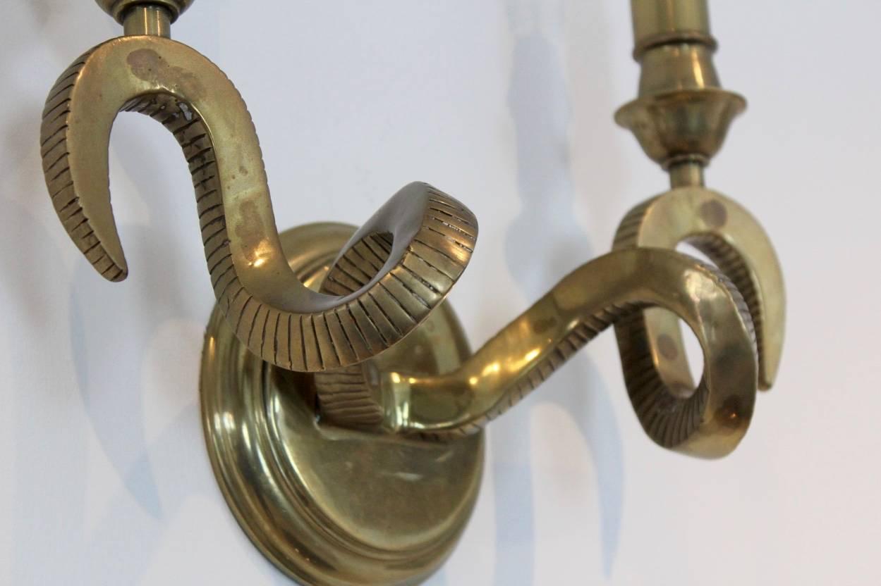A rare set of three stunning brass ram’s head wall sconces produced by Kullmann, Germany in the 1970s. Each two-arm sconce has a handsome backplate with beautiful curled Rams Horns functioning as lighting arms. Very nice Patin on the brass. In