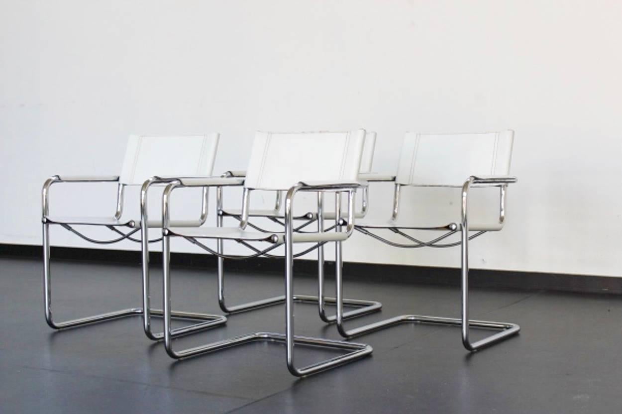 Set of eight Matteo Grassi dinner chairs, designed by Centra Studi, Italy. High-shine tubular chrome frames and handsomely aged leather add an air of distinction to this vintage cantilever chair of the '1970s. Signed 