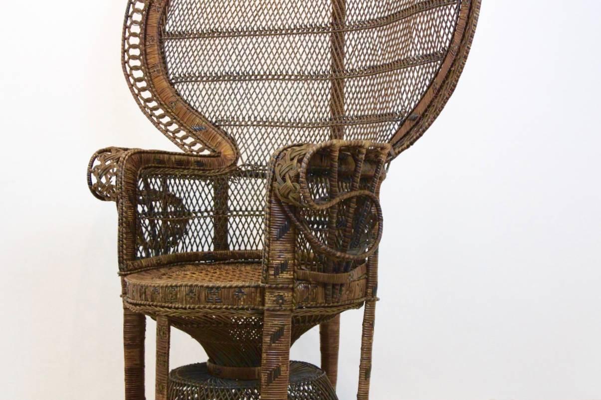 Iconic Peacock chair! Original handmade1970s rattan cane mid-century modern caned armchair. With its woven design handmade from woven rattan wicker cane these full size chairs with their large fan shaped peacock backs were once the iconic chairs of