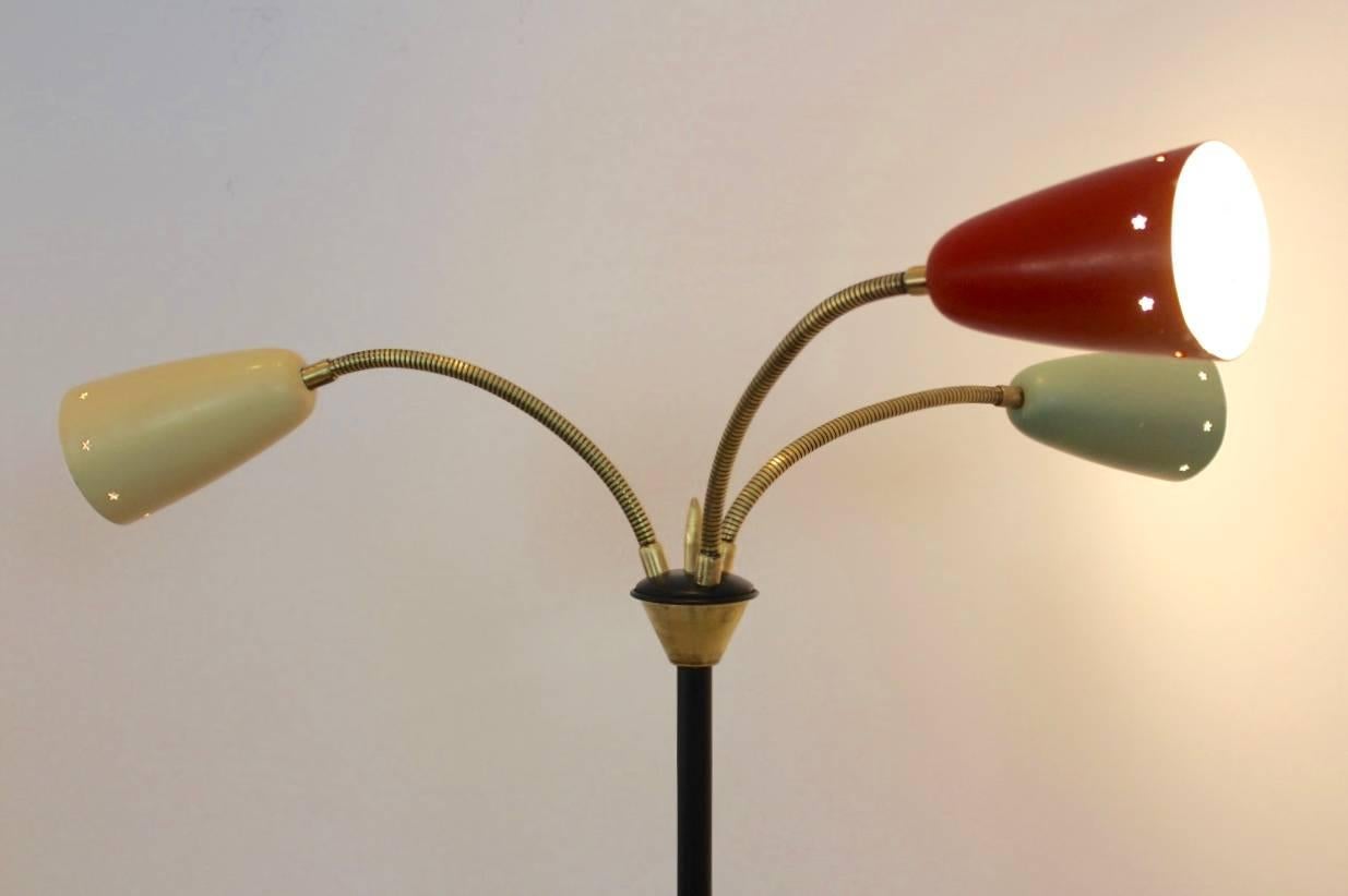 Beautiful and very rare floor lamp designed in the 1950s by H.Th.J.A. Busquet for Hala Zeist the Netherlands. Elegant lacquered black metal foot with three aluminum shades lacquered in a cream, green and red color. Very nice brass adjustable arms