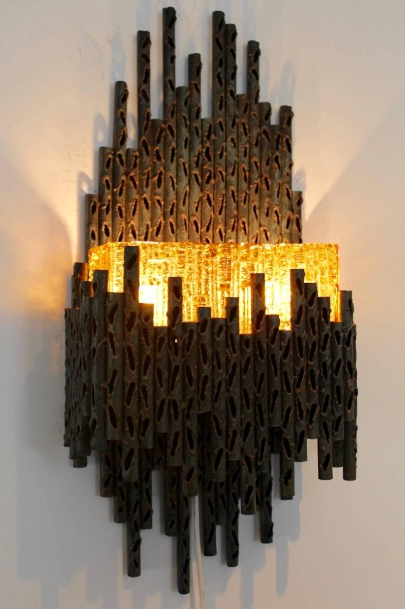 Rare and expressive Brutalist wall lamp made in Italy and designed by Marcello Fantoni. Beautiful sculptured torch cut steel with Murano glass. Completely fine original version. Excellent condition. Beautiful lighting effect.