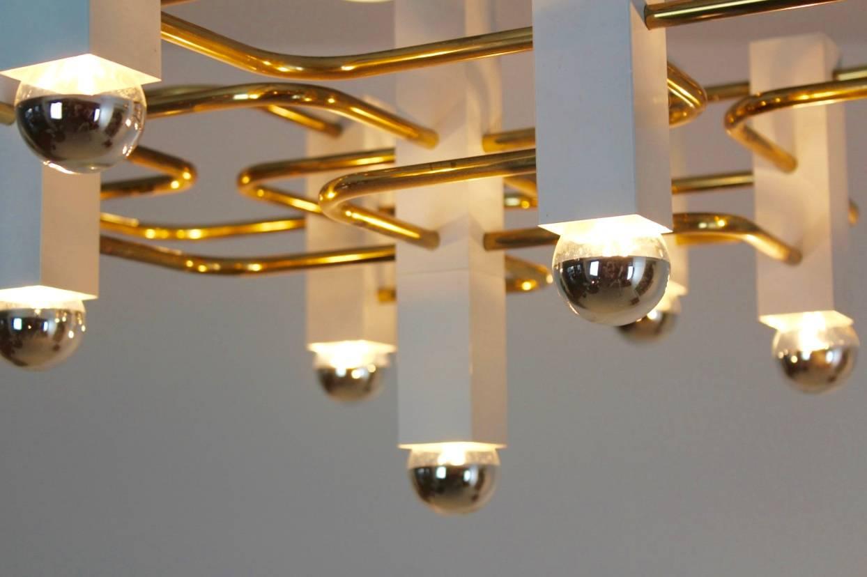 Incredibly rare geometric chrome chandelier by the Italian designer Gaetano Sciolari for the Belgium S.A Boulanger, 1970s. It has a brass frame with nine white bulb holders in total. Condition is very good with some normal signs of wear consistent