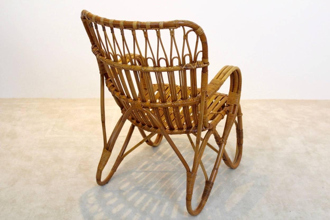 Gorgeous wicker high back lounge chair produced by Rohé Noordwolde in the Netherlands. The chair features beautifully designed bamboo with linear detailing in the style of Franco Albini. Very good original condition. Outstanding design.

Also