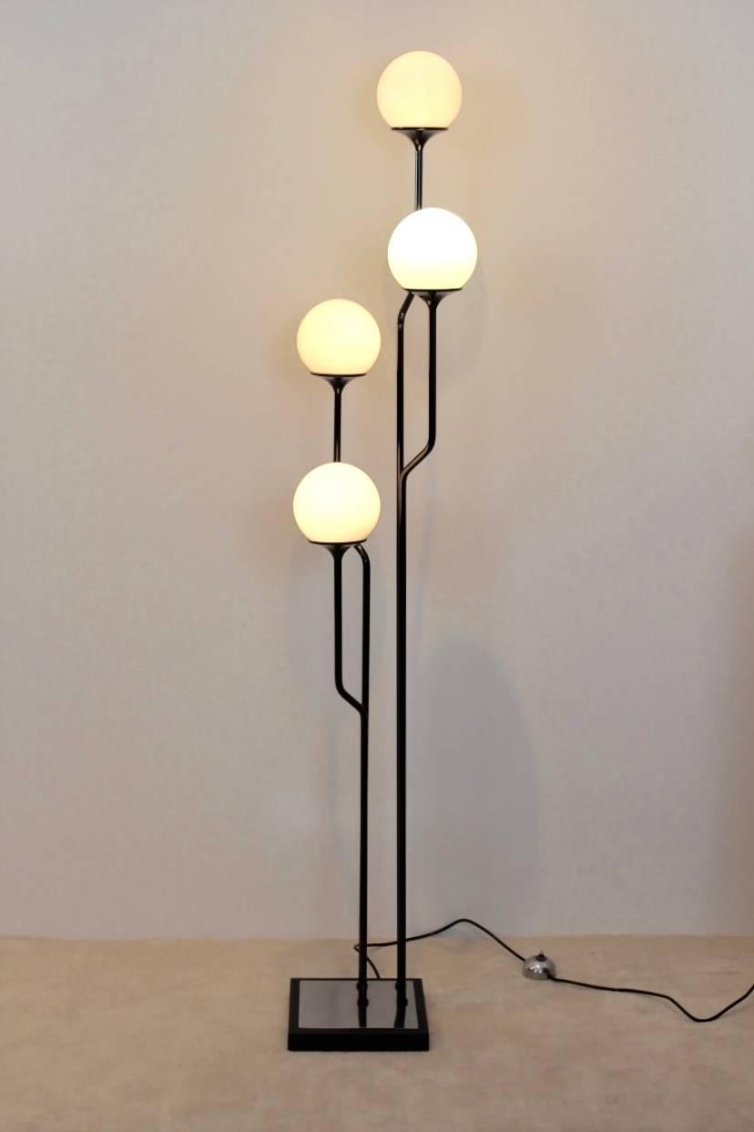 Iconic Goffredo Reggiani Italian floor lamp made by Studio Reggiani, Italy, 1960s. Four black arms with its original opaline glass bulbs at its end. In excellent good condition.
   