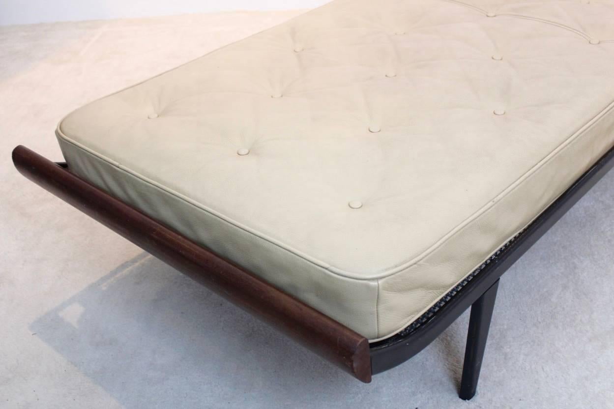 Stunning Cleopatra daybed in teak and with steel base. Designed by Dick Cordemeijer for Auping in the 1950s. Teak wood ends with enameled black metal frame. Frame in original condition with visible scratching to the enameled frame. This daybed comes