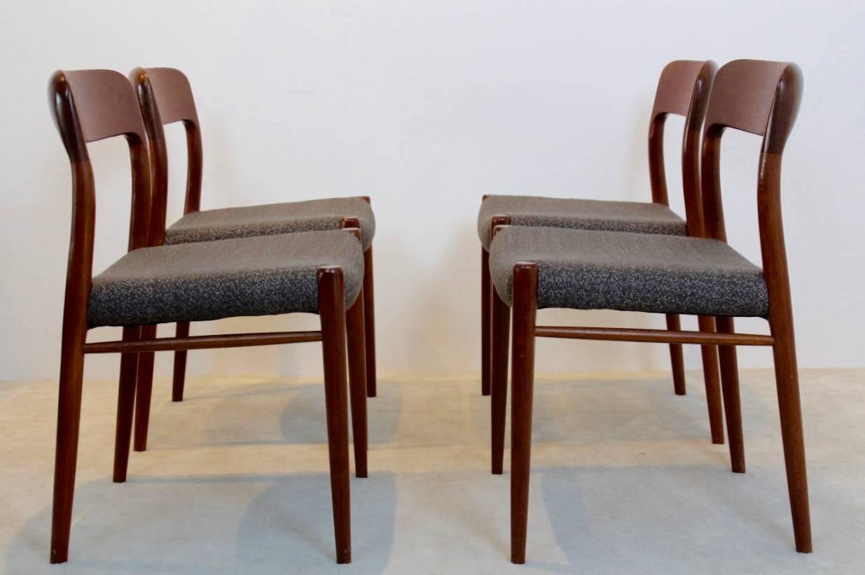 Set of four dining chairs designed by Niels Otto Møller and manufactured in Denmark by J.L. Møllers Møbelfabrik A/S during the 1950s. Each chair features sculpted teak backrests and has been recently reupholstered with high quality ‘Ploeg fabric’.