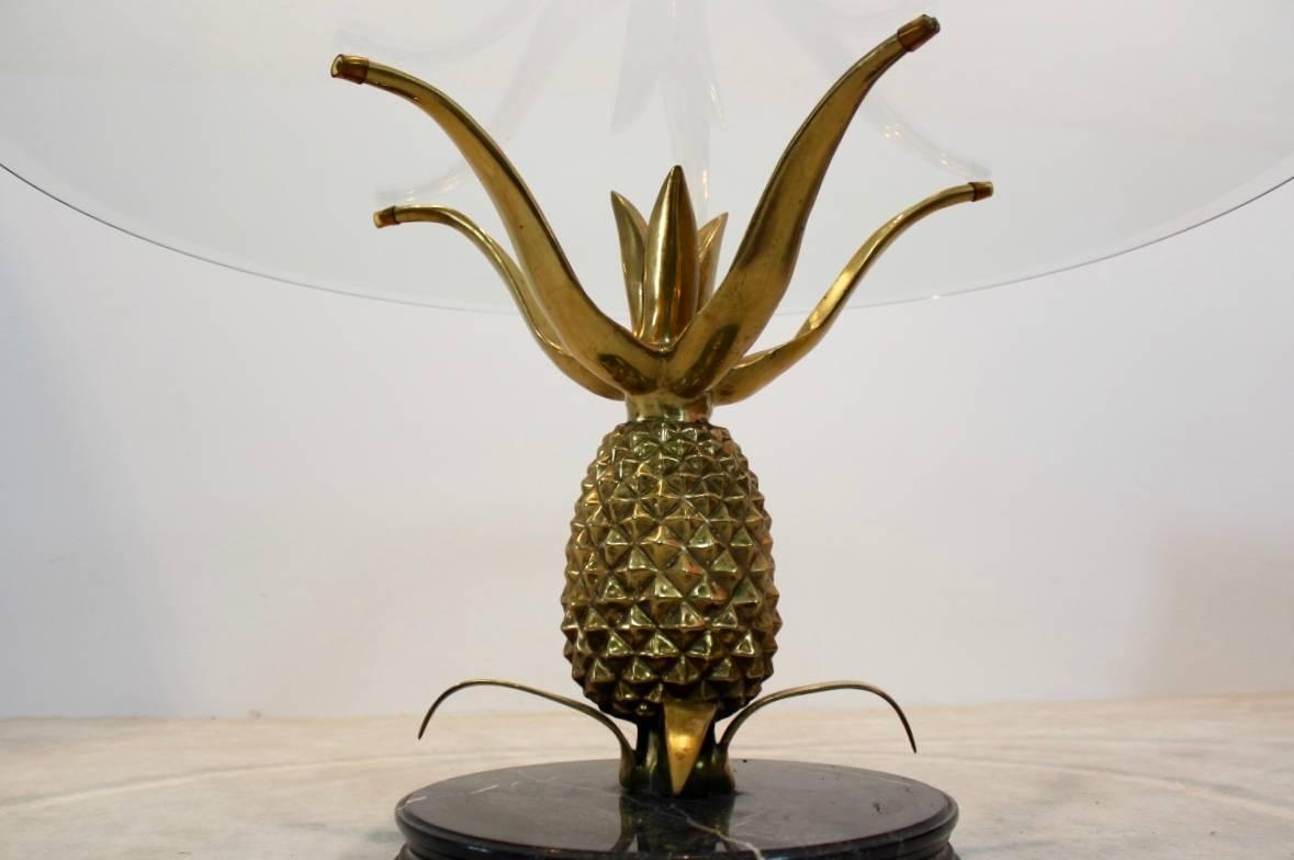 A truly eye-catching, unusual brass metal table, fashioned in the shape of a Pineapple on an elegant marble base and with a glass top. The tabletop comes in matching facet glass. This table is the perfect height to be used as a wine table and