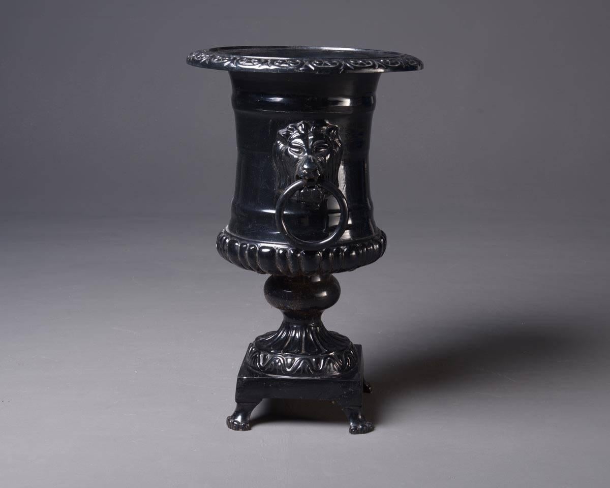 Pair of very big flower pots, formed like antique urns. Two handles are attached in lions` heads. Each urn is standing on four lion's feet.
Material: cast iron, lacquered black
Measurements: Height 87 x diameter top 56 cm; inner diameter 31