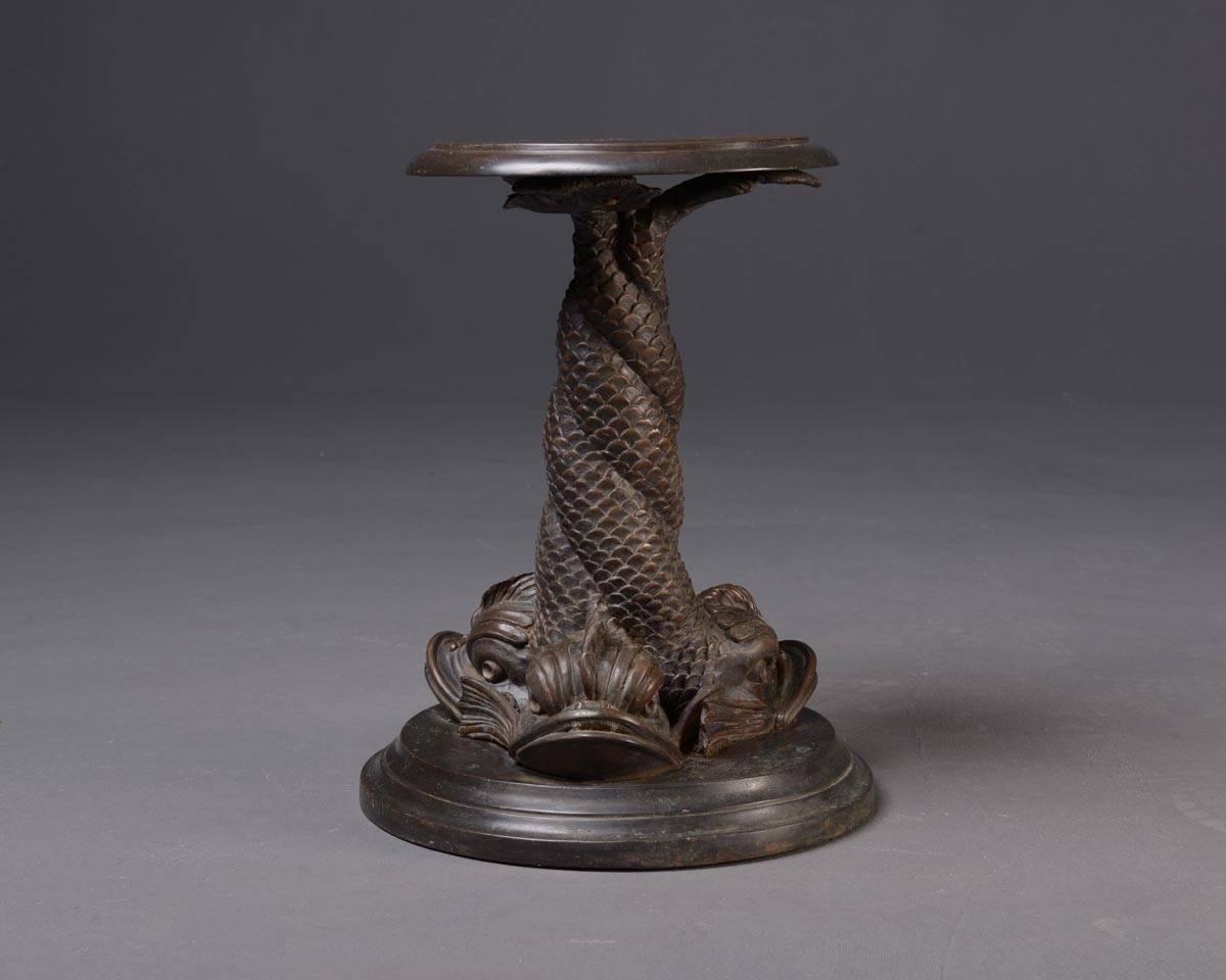 Pair of flower stands or stools, classical style. The leg is formed by three intertwined dolphins 
Material: cast iron, bronzed
Measurements: H 50 x floor space ca. 40 cm; top`s diametre. 31 cm
Condition: Good.