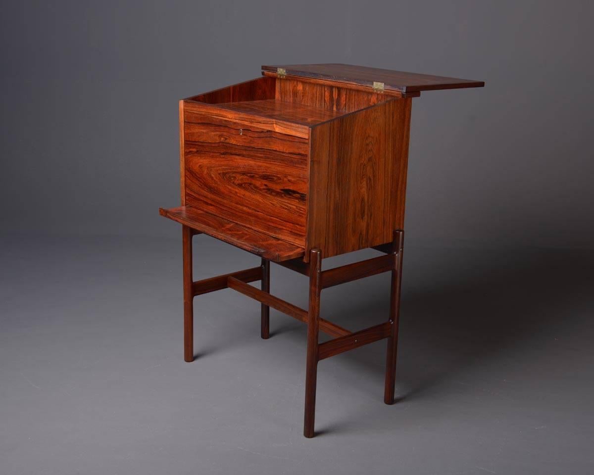 Very well made high desk in rosewood, produced by VM Møbler, Denmark in the 1950s-early 1960s. Base made of solid rosewood, closet veneered. Interieur with two drawers and light. High qualita craftsmanship. Rare and very elegant object.