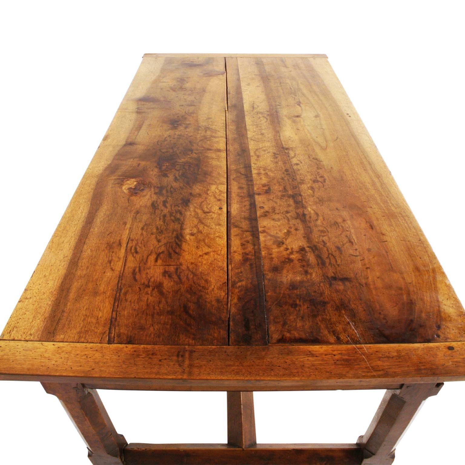 Beautiful walnut table with exceptional patina and wear patterns showing many years of use in the same household.

Features a standard drawer in the middle but where this piece stands out is the faux drawers on either side. Instead of pulling out,