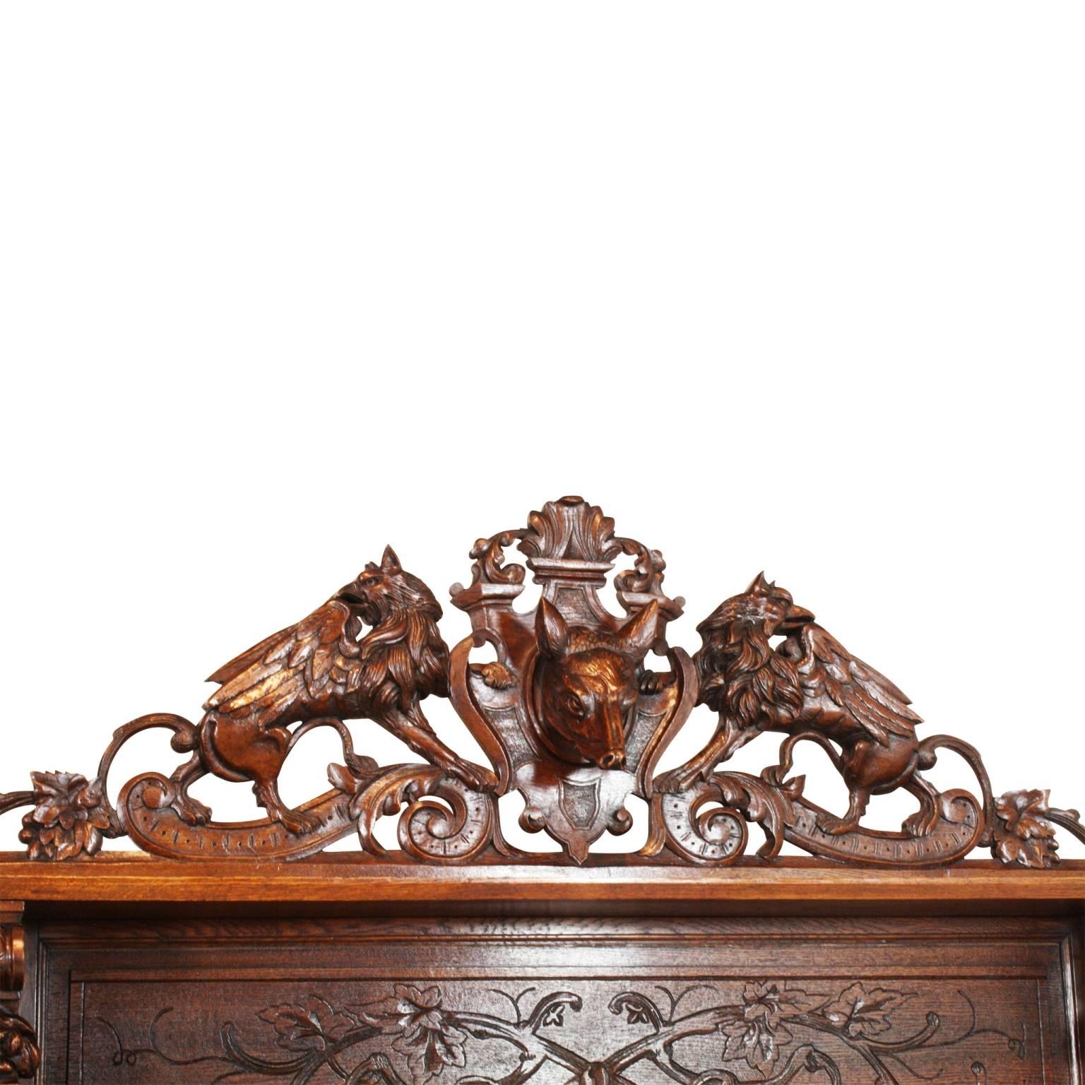One of the finest examples we have had in our shop of French hunt cabinetry.
The lighter stain shows off the carvings and detail much better than many pieces of this style in a darker walnut finish. The upper crown features a fox and griffins. The