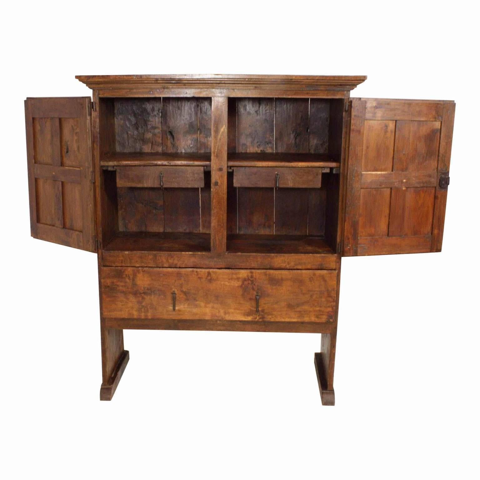 Beautifully rustic patina and a wonderful interior two centuries in the making. Two Seamless, hand hewn, one inch thick planks act as the sides and legs of the cabinet. A large bottom drawer and two smaller interior drawers with original matching