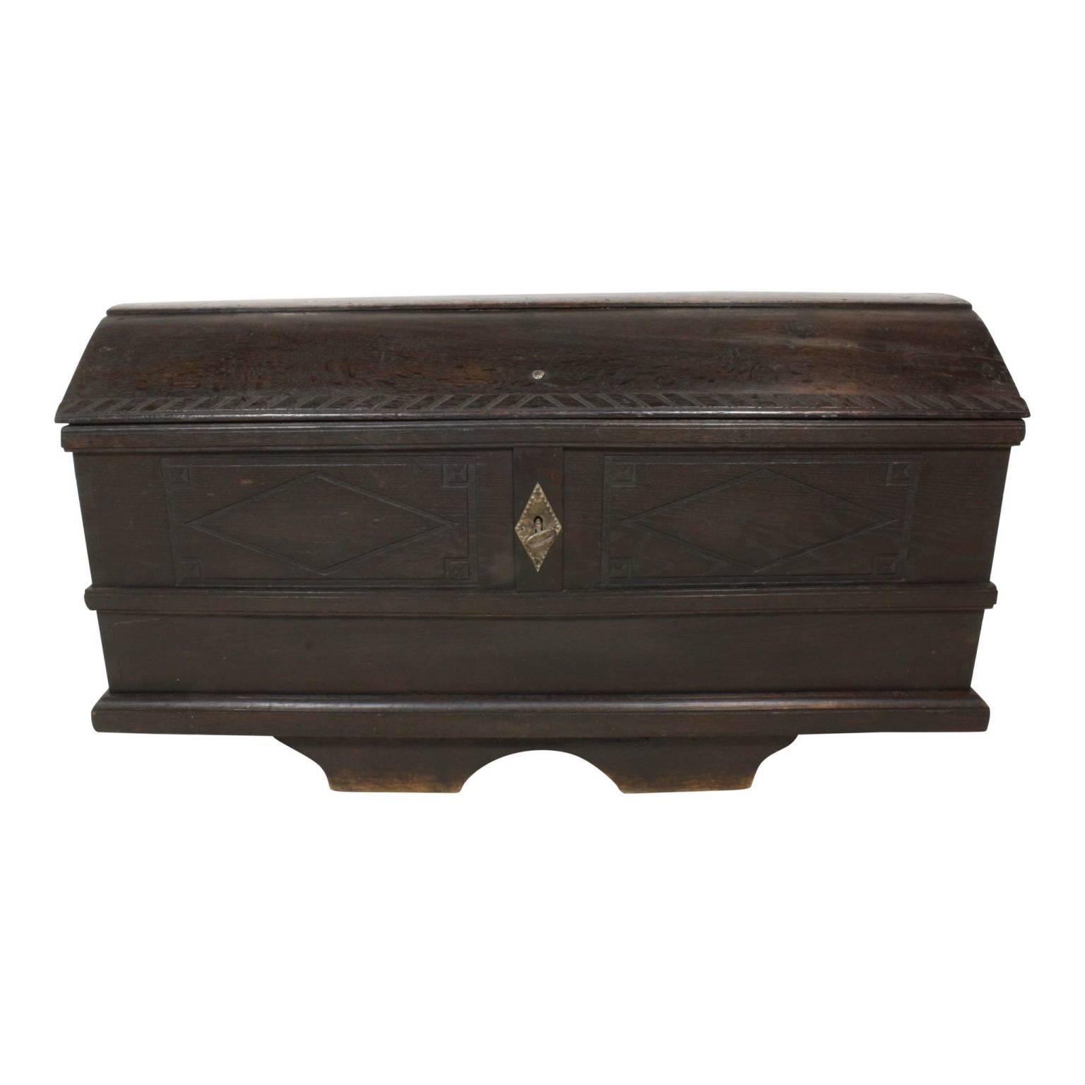Unique centered feet make up the base of this piece that features the original hinges and handles. The beautiful interior patina and interior decorative hinges help make this piece look equally good open or closed.