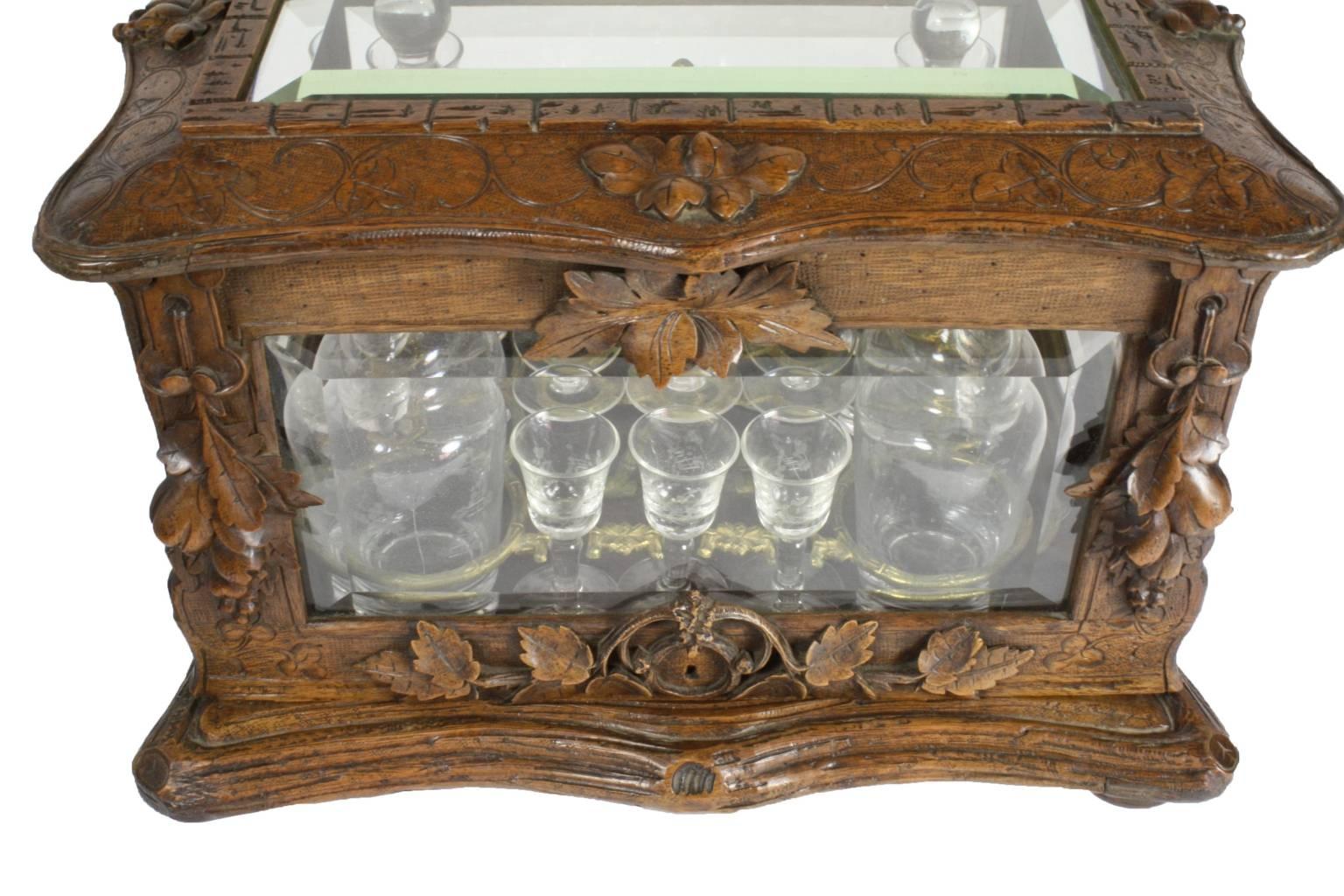 Carved Swiss Walnut Liquor Box with Four Decanters and 16 Cordial/Aperitif Glasses For Sale