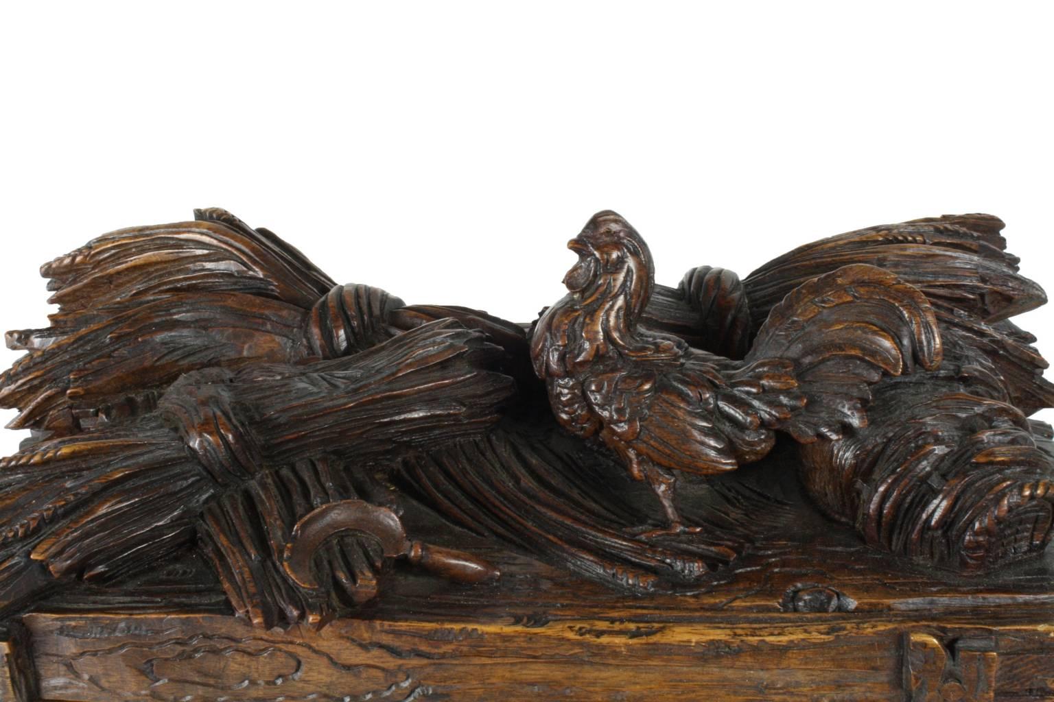 This lovely carved Black Forest box features a highly sought after carving of farm fowl, nestled among bundles of wheat. The interior is lined with well maintained salmon velvet. 

No key is present.