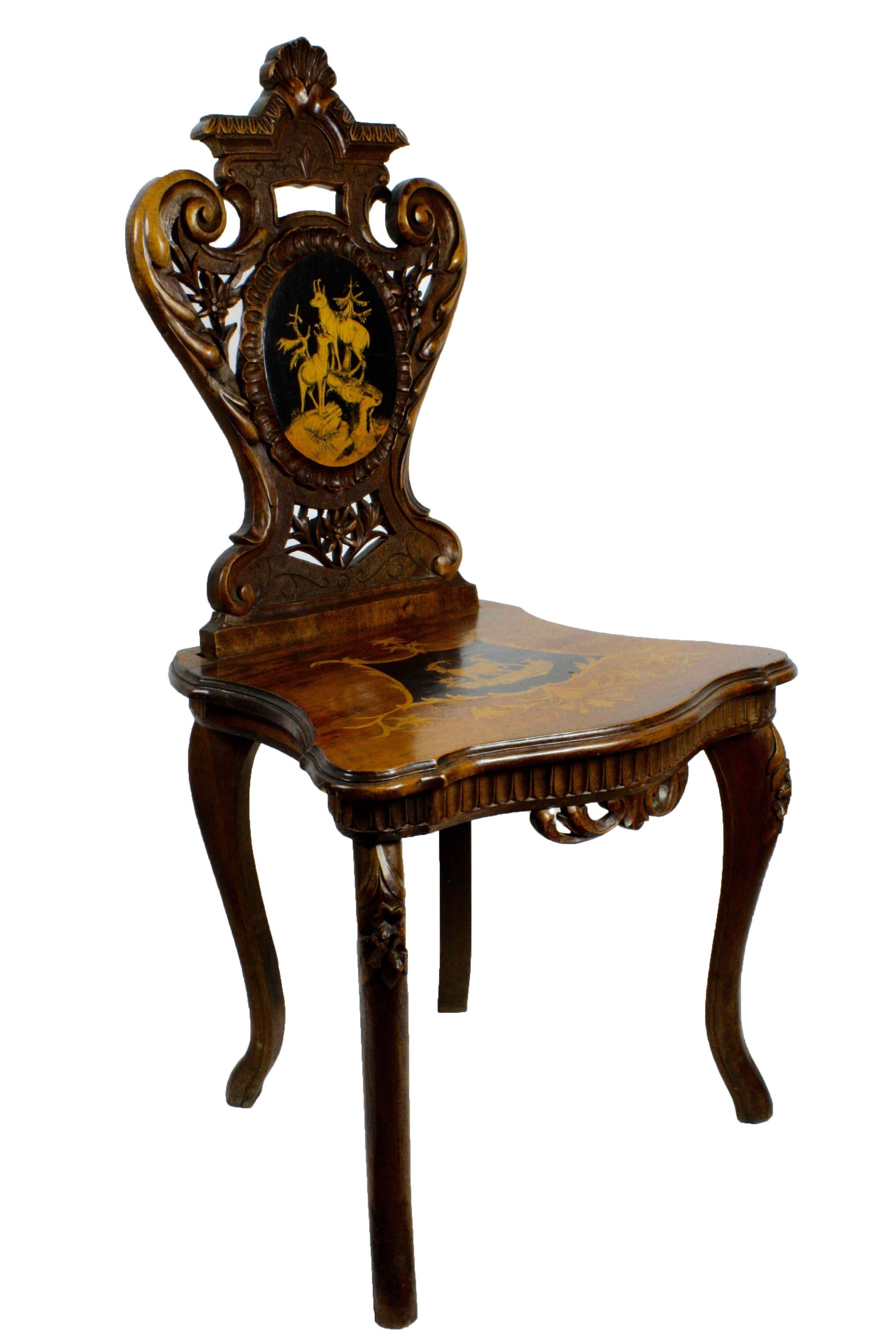 A beautifully executed and inlaid example of late 19th, early 20th century, Brienz Swiss carving and craftsmanship. Featuring Ibex and chamois inlay in the seat and back, with edelweiss and lovely scrolling.