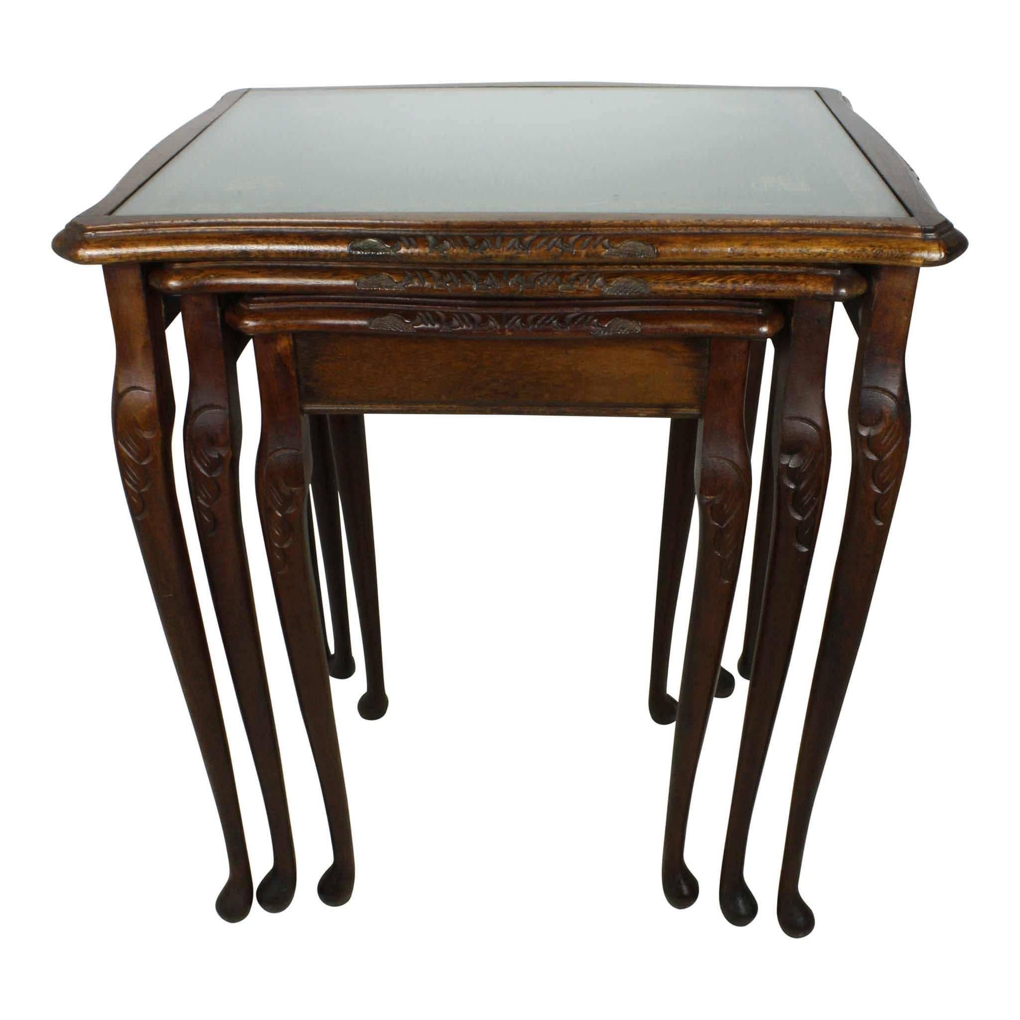 This set has three tables with green, leather tops with gilt tooling on the edges. Each is covered with removable glass. The Queen Anne legs give an elegant look. Dimensions for the large table: L 20" x W 15.5" x H 21.75". Dimensions