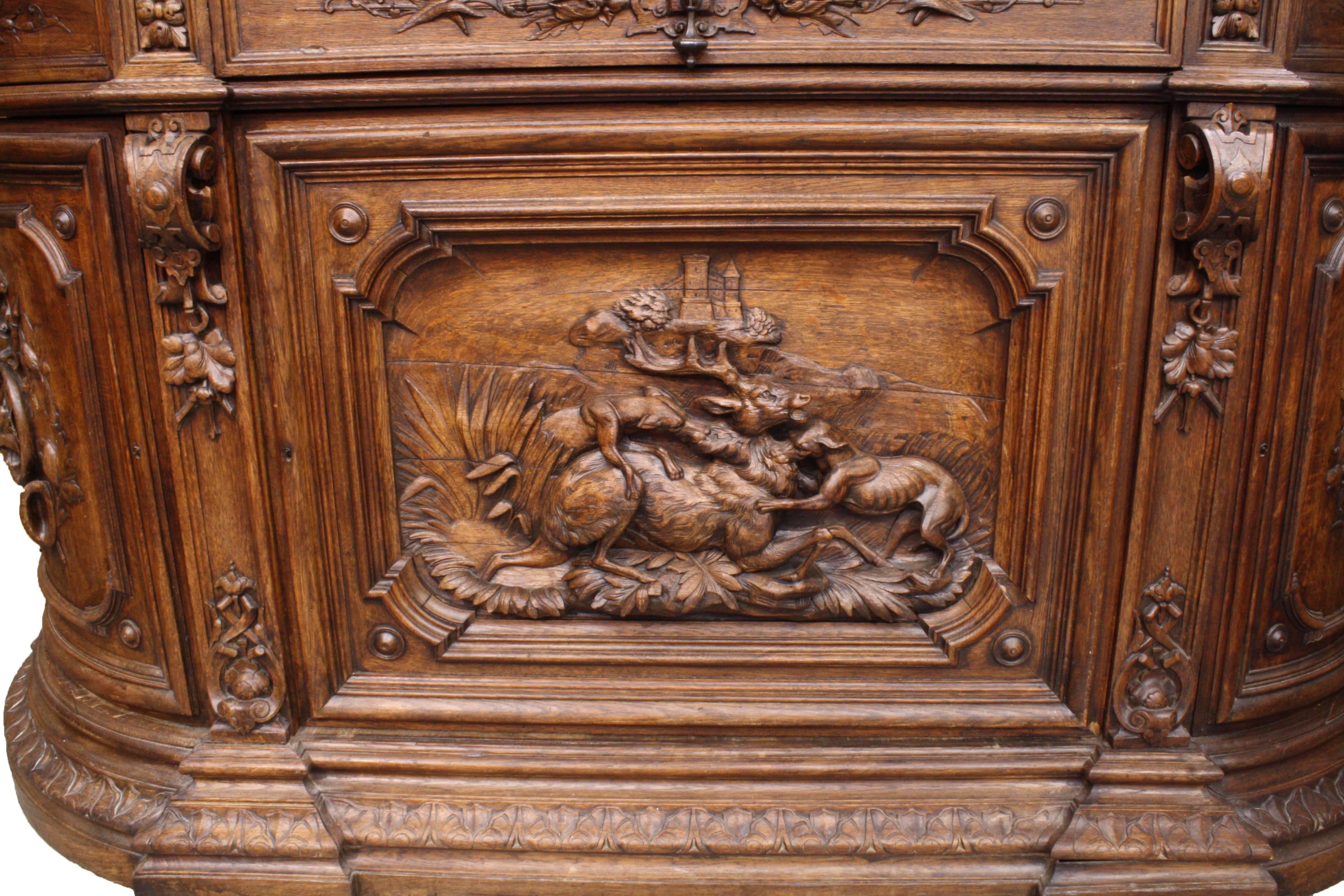 The height and width of this magnificent French cabinet make it one of the largest pieces of its type we have seen or had on offer. The beautifully carved front door panel features a red stag being subdued by two hunting dogs, with a large castle on