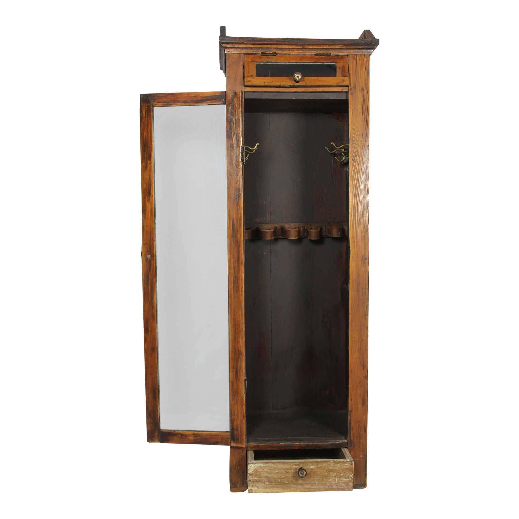 While we don't know the origin of this wooden locker, it appears to be a storage locker for baseball gear. Behind the glass door, the inside features four double hooks, two on each side, and a tacked and snaking leather strap (used for baseball