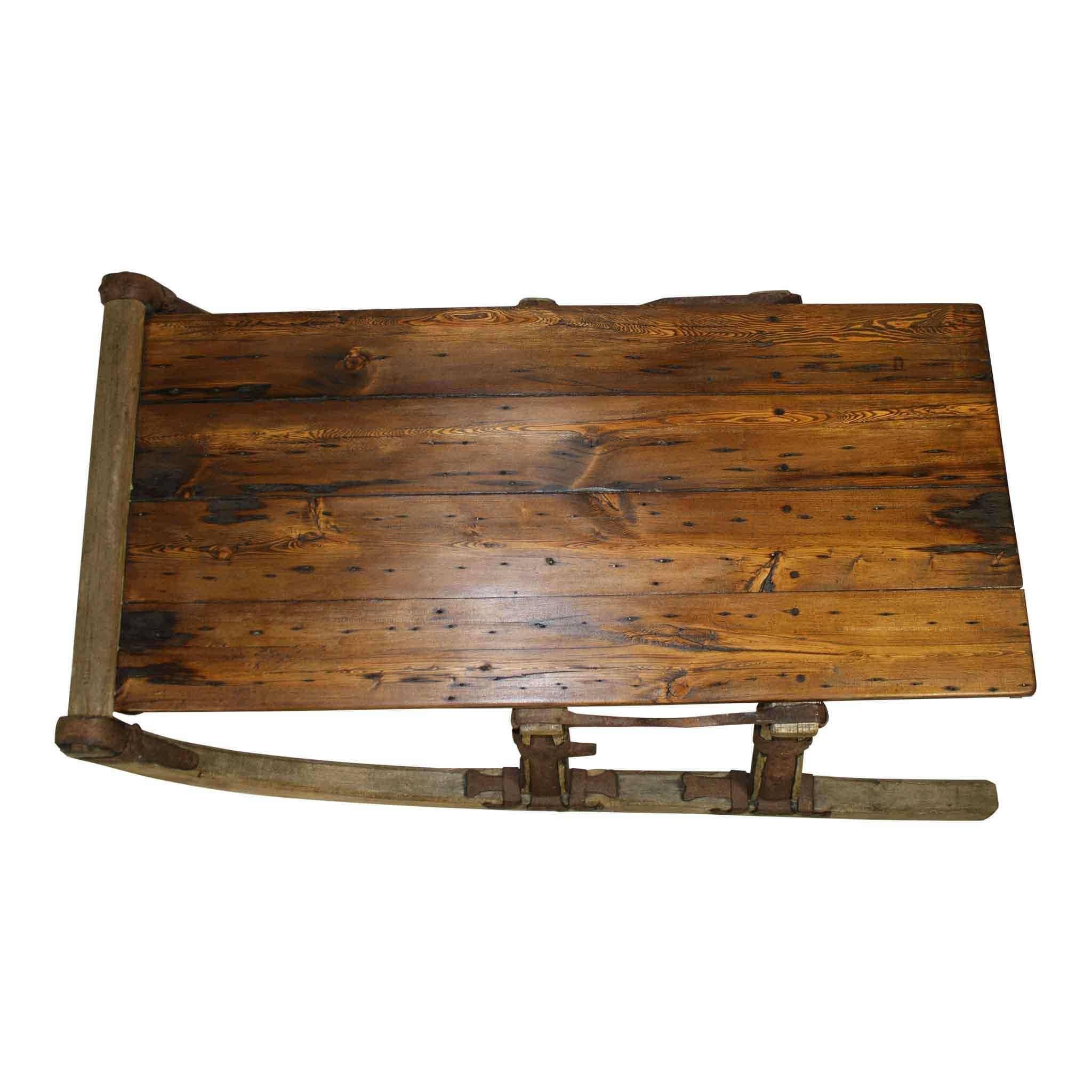 This runners of this re-purposed Russian sleigh, with lovely iron embellishments, has been made into a great looking coffee table. Reclaimed barn wood has been use for the tabletop, finished in a pleasing walnut stain.