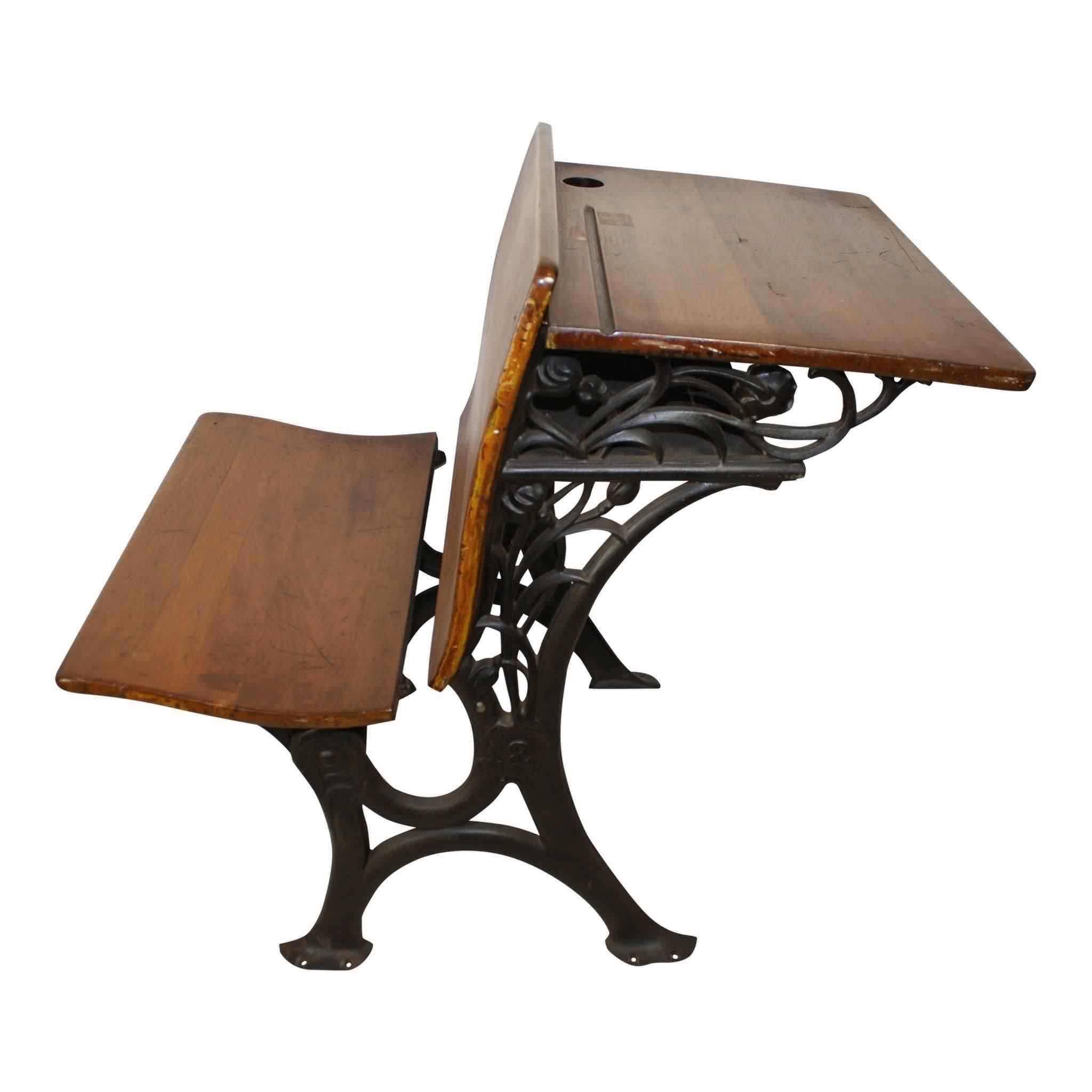E. H. Stafford Mfg. Co. of Chicago manufactured this child's school desk in the early 1900s. Designed to serve as the desk for the student behind, it has a folding seat, tray, ink well hole, and storage shelf. The desk top is 23.75" x 16".