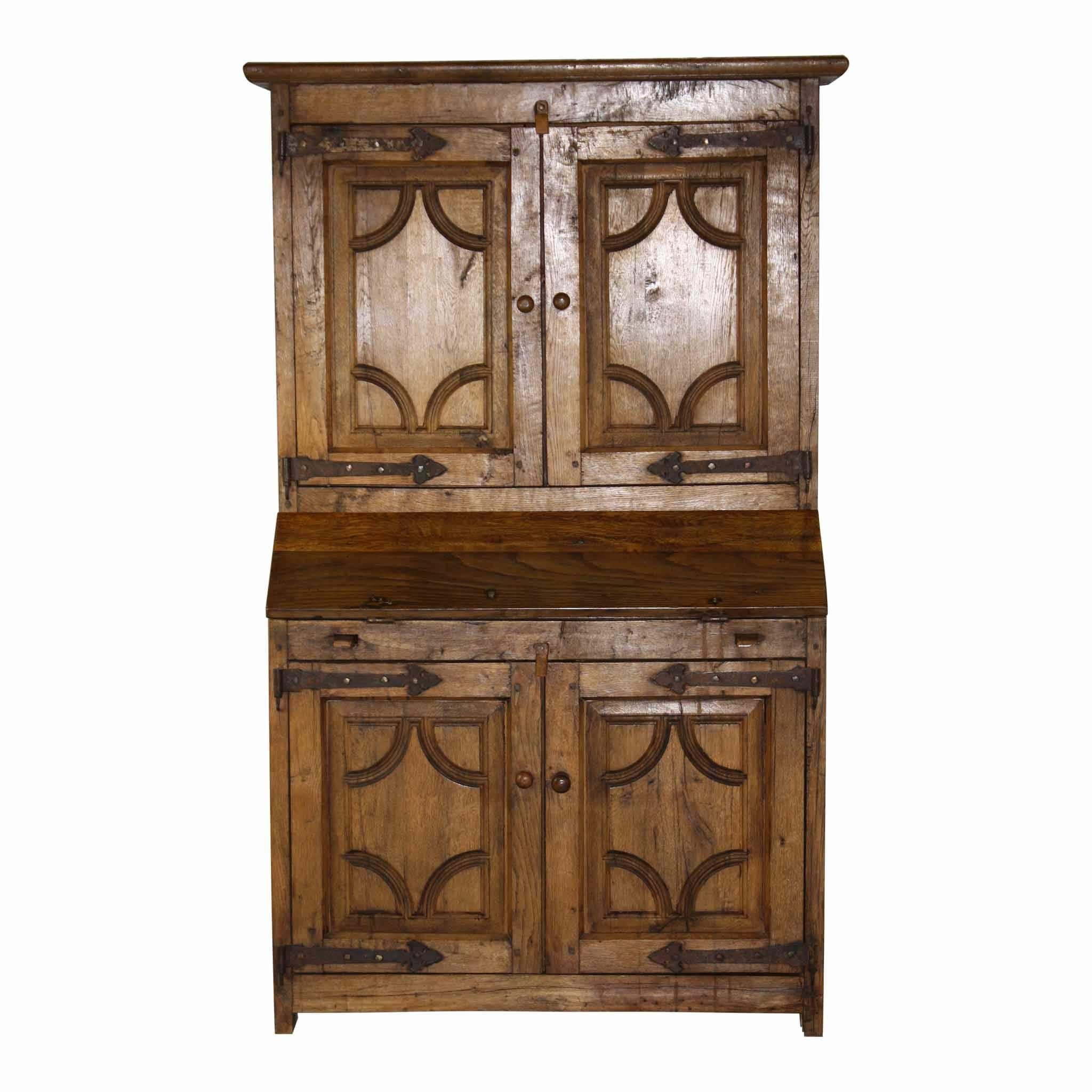 Behind the drop front, the desk has three storage drawers with wood knobs. The interior of the top and bottom galleries contains a single shelf. Decorative metalwork hinges add to the beauty of the piece.