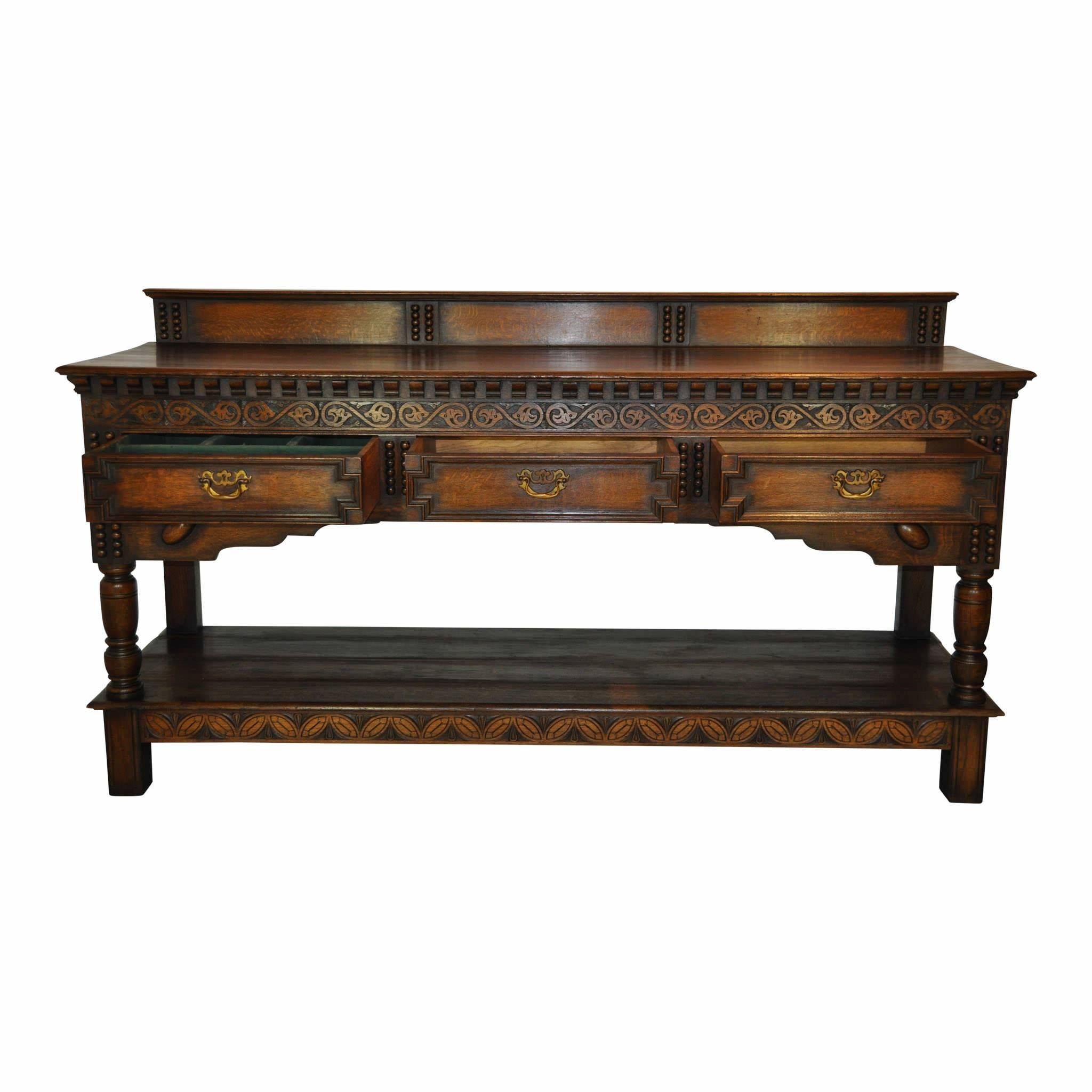 The clean lines of this server are accentuated by decorative floral carvings and beaded trim. The underside trim of the counter is comprised of mini corbels, giving a nice juxtaposition with the decorative carvings. Three drawers for storage, one