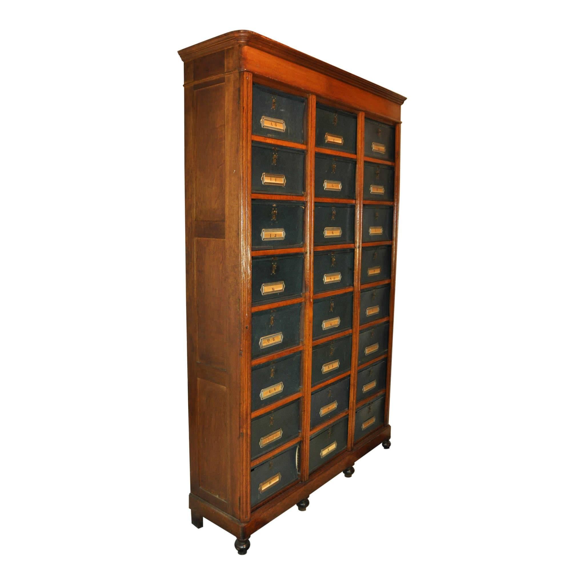 Plenty of space is available in this 24-door file cabinet. Each removable box has a fold down door. The centre and outer trim panels lock keeping the boxes secured. Because of the size of this piece it was likely owned by a lawyer or accountant. One