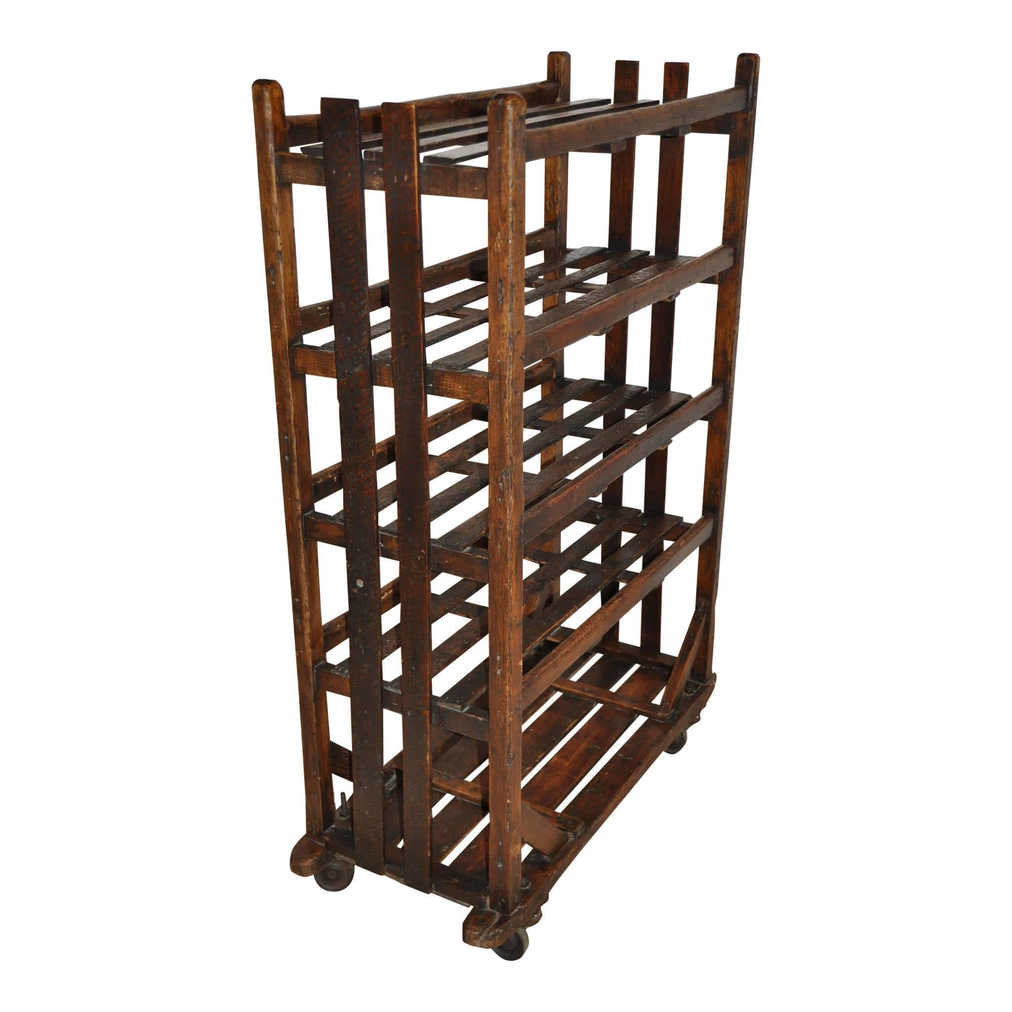 Originally used for drying shoes, this five shelf rack has so many possibilities! Use it in your own home for storing wines or pantry items, as a book shelf, or in a mud room as a shoe rack. The metal wheels make it easy to move anywhere. There is
