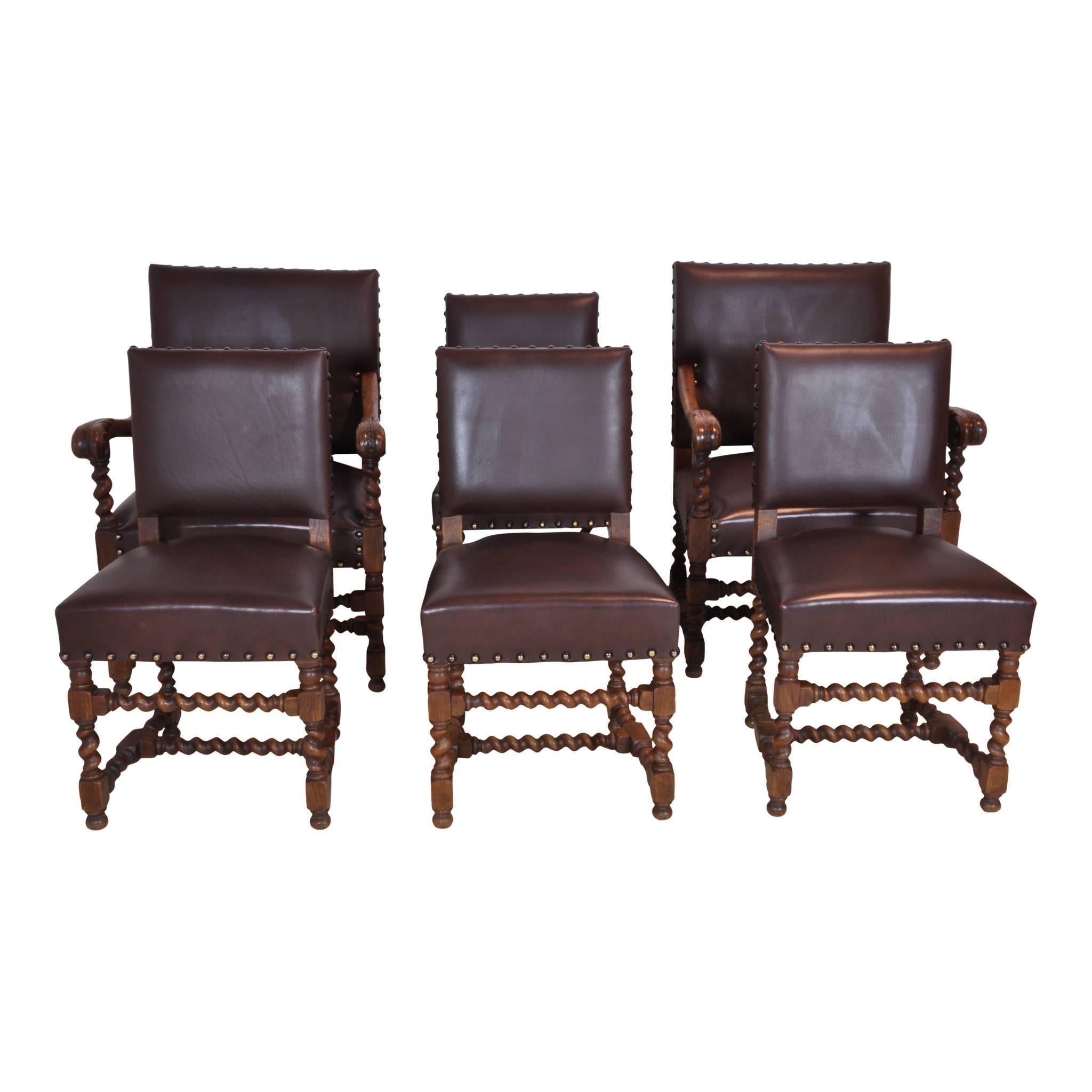 This set of six chairs consists of two armchairs and four side chairs. The chairs are upholstered in dark brown leather and secured with large brass pinning. Each chair has barley twist legs, side stretchers, front stretchers, and centre stretchers.