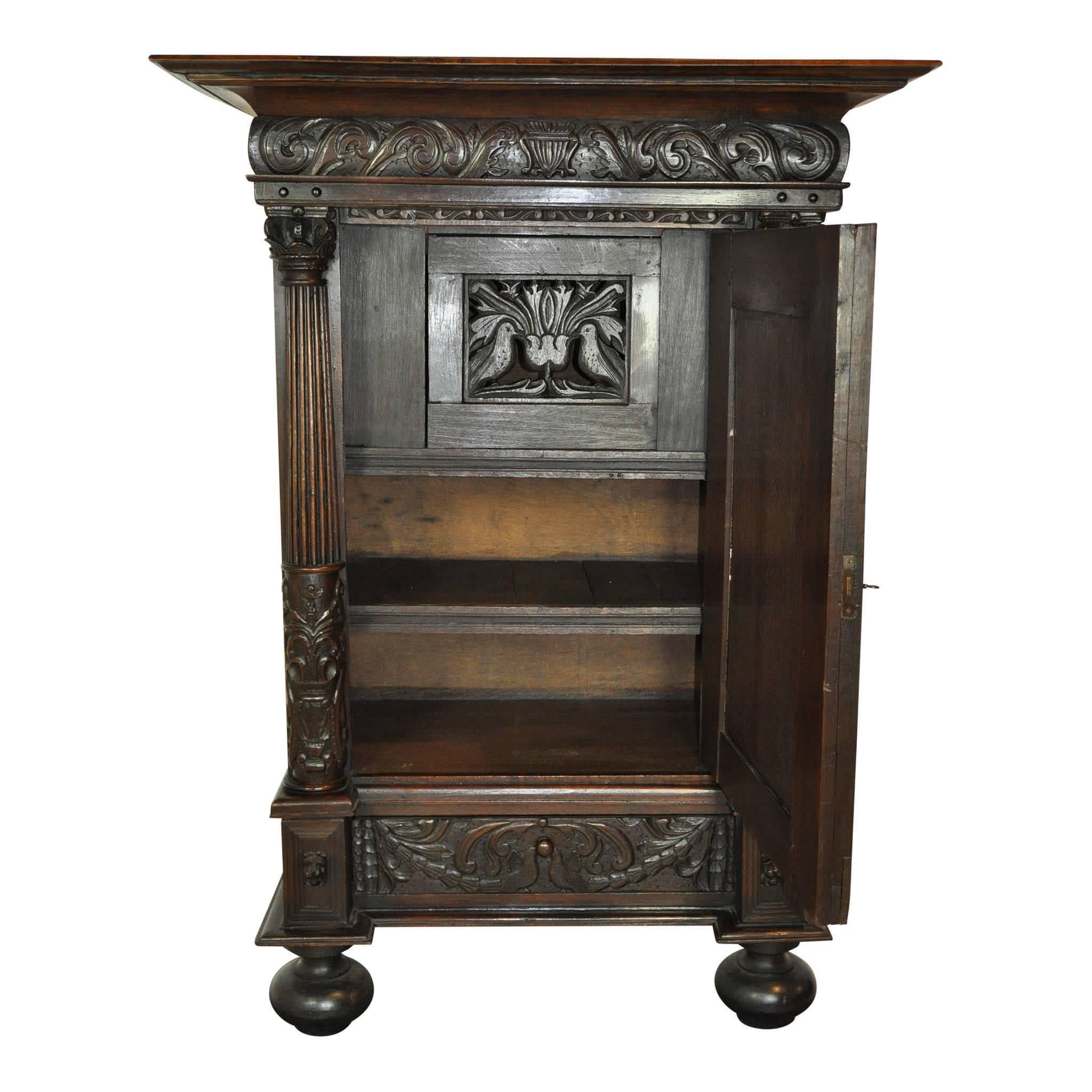 Adorned with putti heads and doves, this wedding cabinet exemplifies quality. From the ornate detail on the front and sides to the quarter sawn white oak used on all parts of the cabinet (even the back), everything about the piece shows the extreme