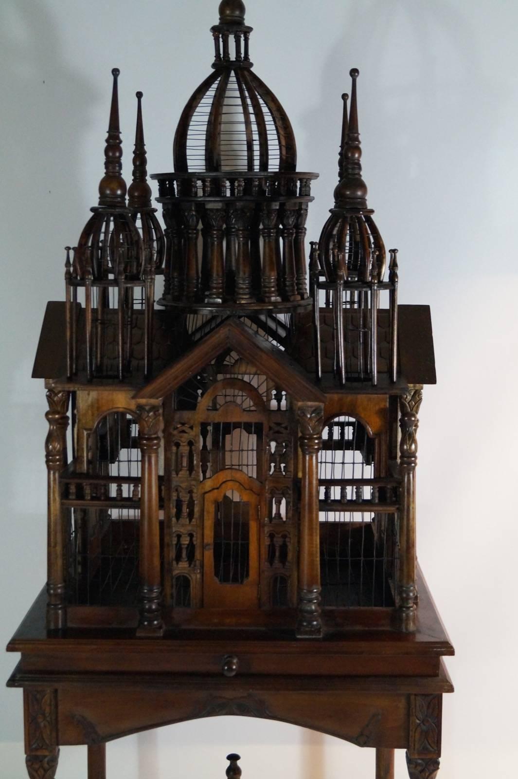 Impressive, grand mahogany bird cage on stand, Italian. Early 20th century.
Beautiful detailed carved wood. The cage can be removed from the base.
Measures: H x W x D 200cm x 70cm x 70cm.