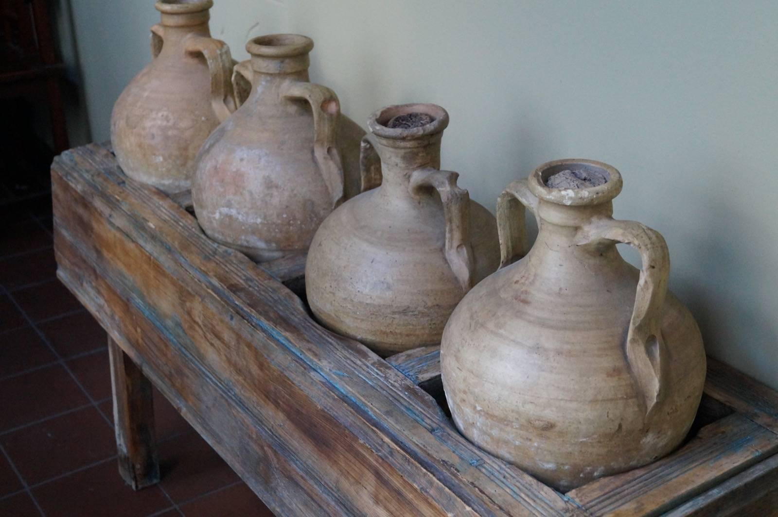 Rare set of four olive oil jars on a matching table. Beautiful patina,
Italy, late 19th century.
Measures:
Table: Height 60cm x width 135cm x depth 40cm.
Jars handmade so slightly different measurements: Height 45cm, diameter 30cm.

Five items