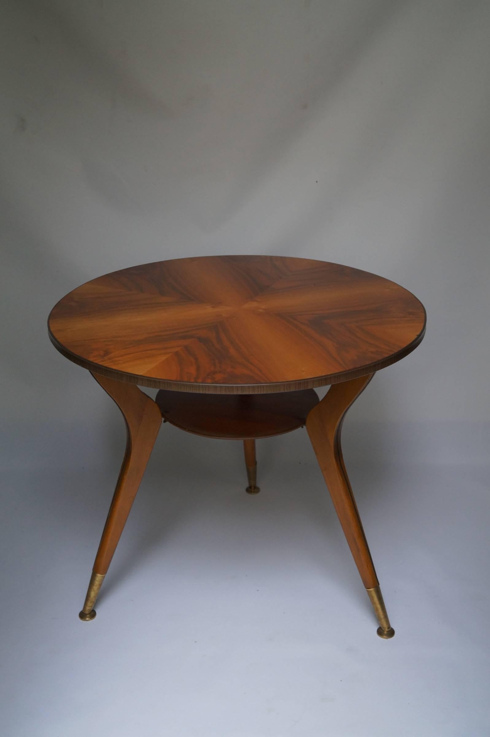 Italy, 1950s.
Brass legs and a wonderful wood veneer top.
Measures: Height 60cm, diameter 70cm.