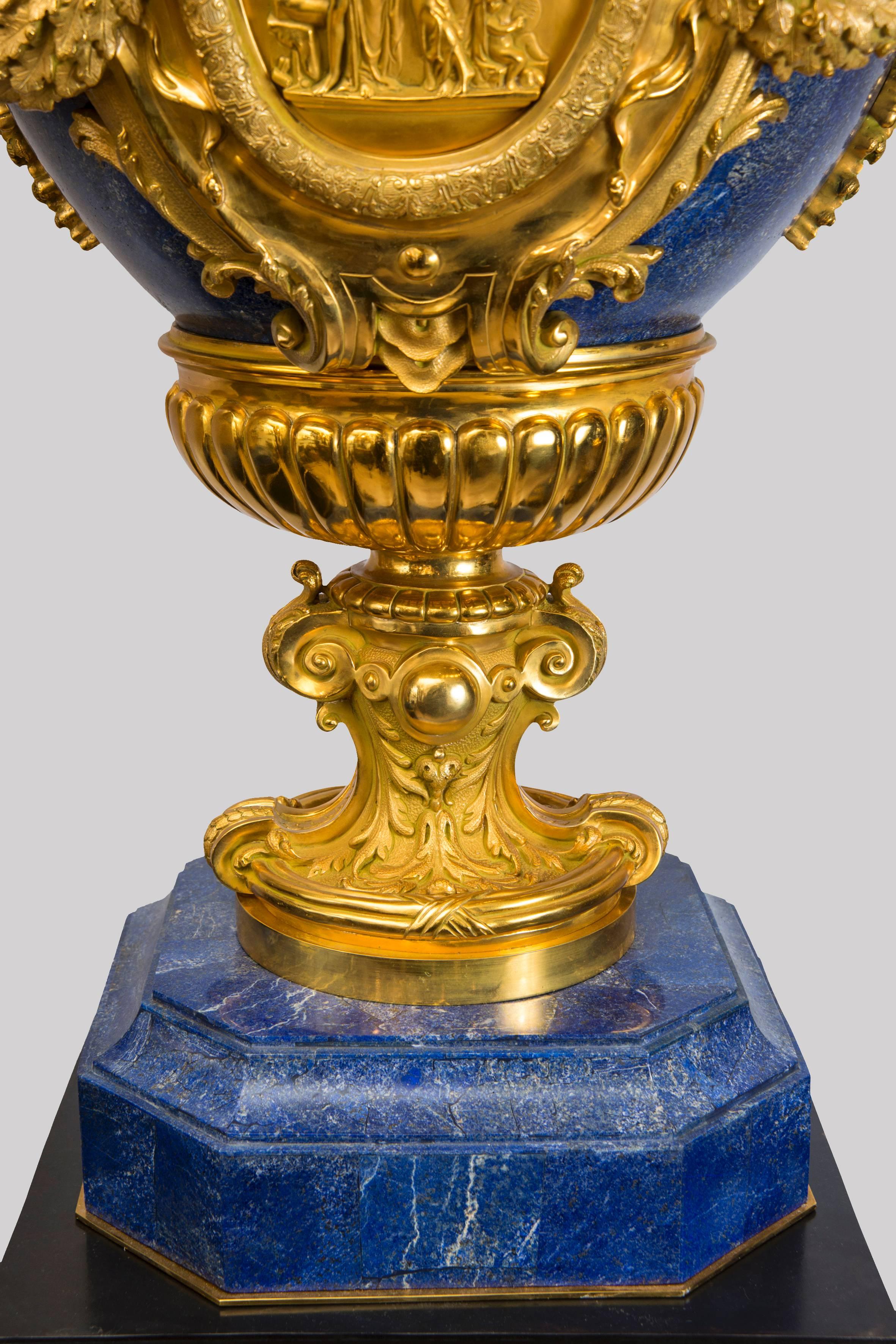 Exceptional pair of vases in Louis XVI style gilt bronze mounts and Lapis lazuli (semiprecious stone). A 1m x 70cm antique decor and fauna heads medallion. They are placed on a pair of Empire style jackets in black bronze crown of laurels