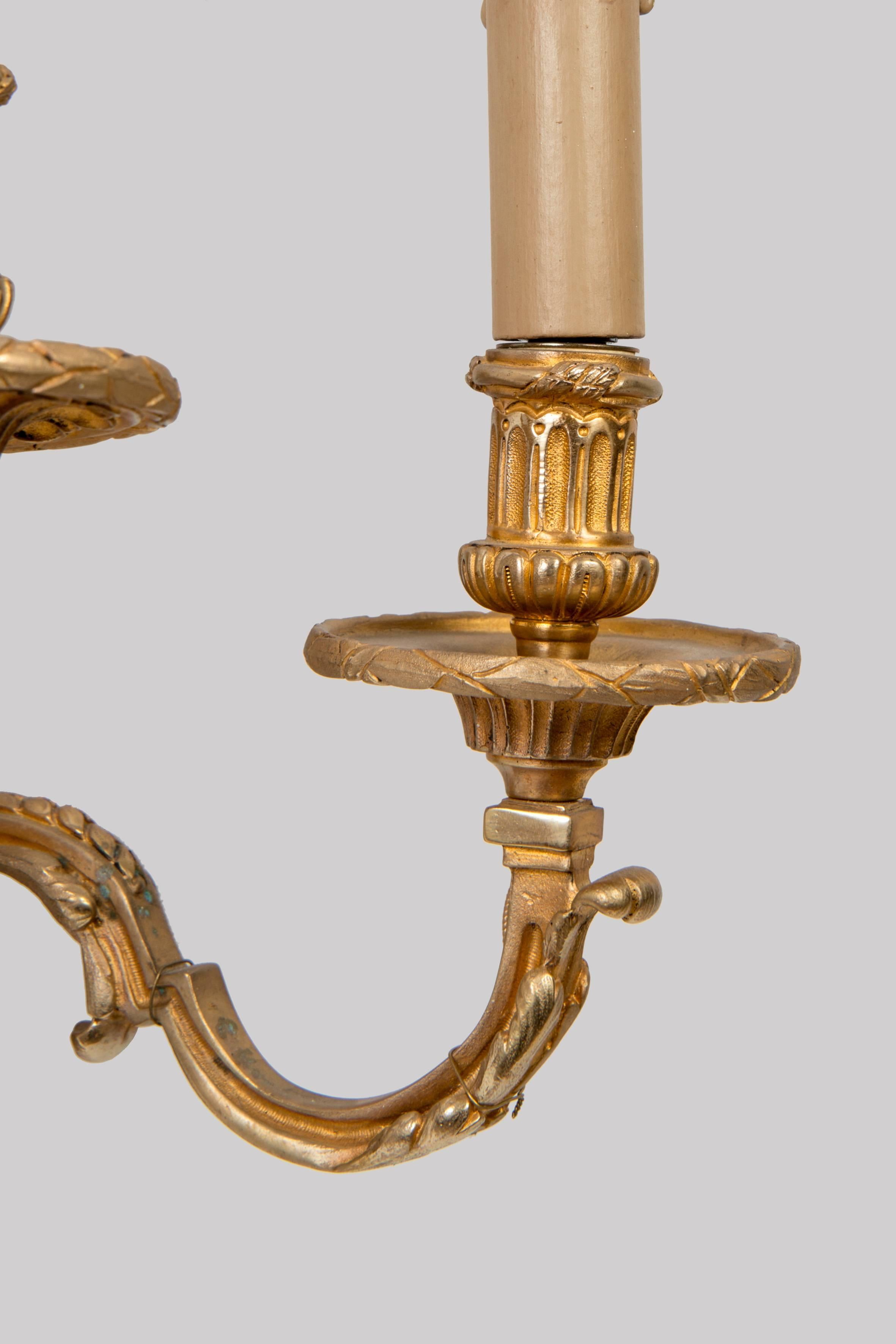 Beautiful pair of Louis XVI style sconces decorated with gilded bronze heads of rams. Period: Late 19th century.
