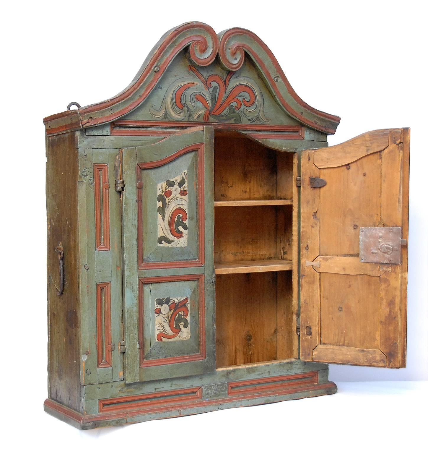 A 19th century rosepainted hanging cupboard from Numedal, Norway. With original lock, key and ironsuspensions.