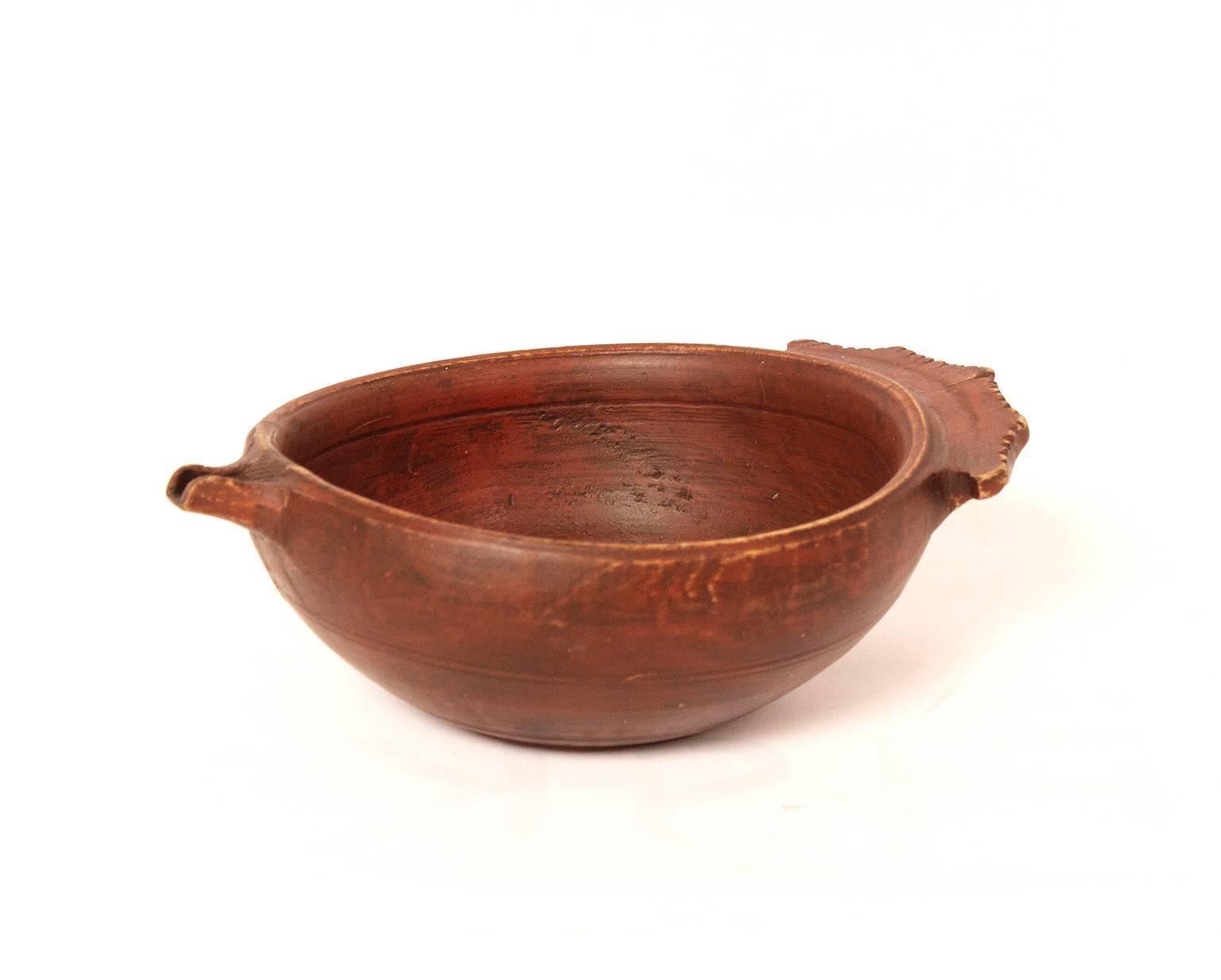 A 19th century small red painted wooden ale bowl.